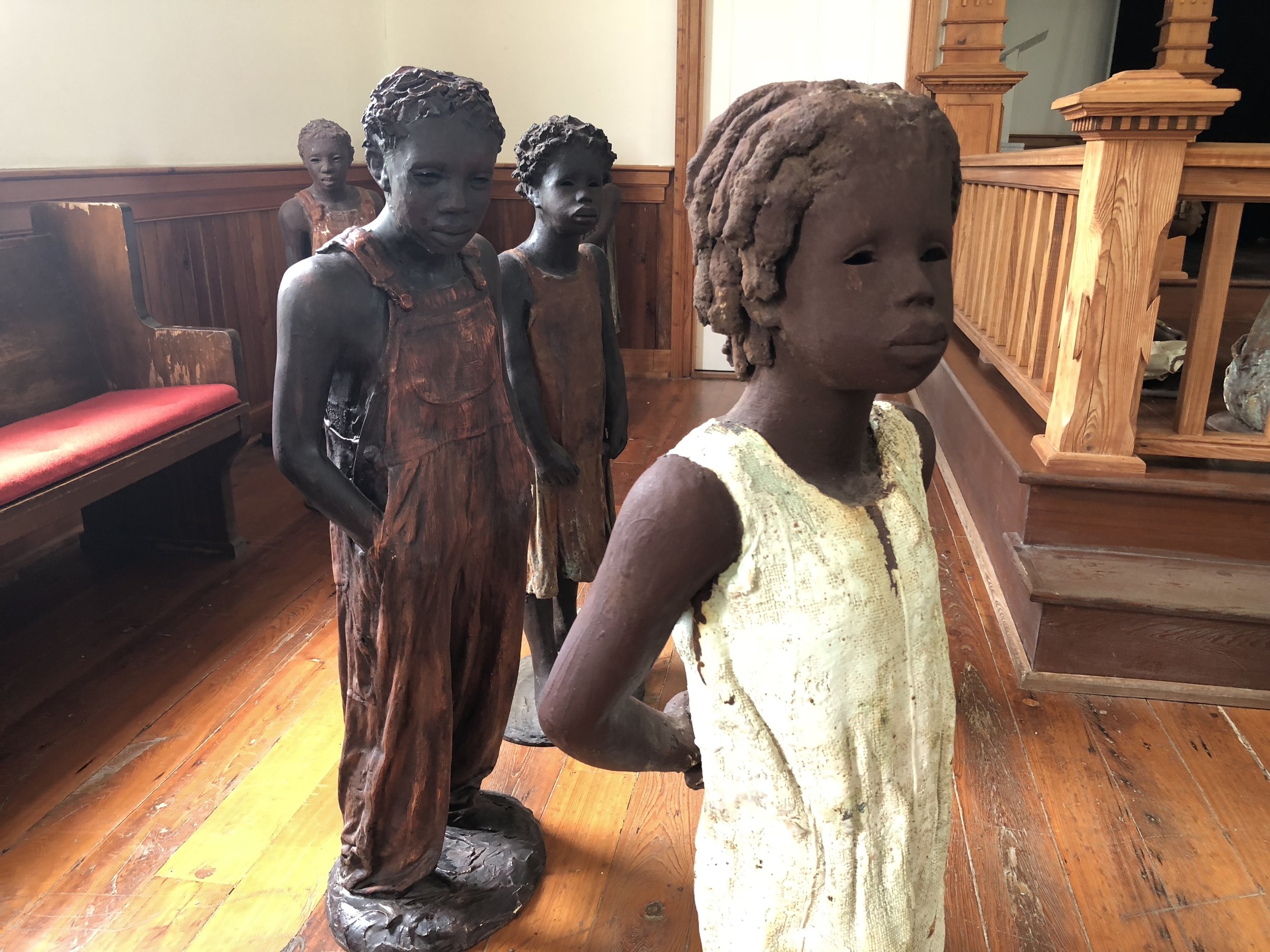 The statues of slave children inside the church