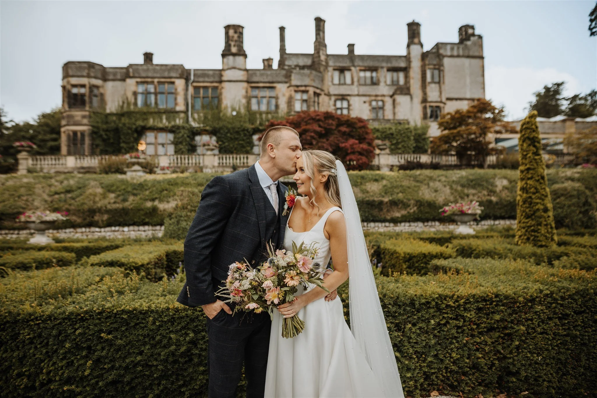 Wedding couple getting married at Thornbridge Hall in the Peak District. Taking photos in the aesthetic Italian Garden