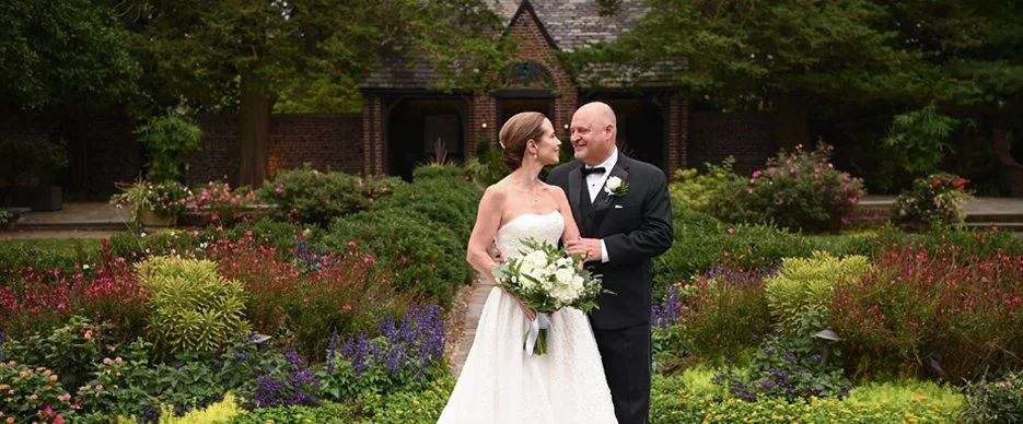 Catherine + George on their wedding day in the formal gardens at Greenville Country Club