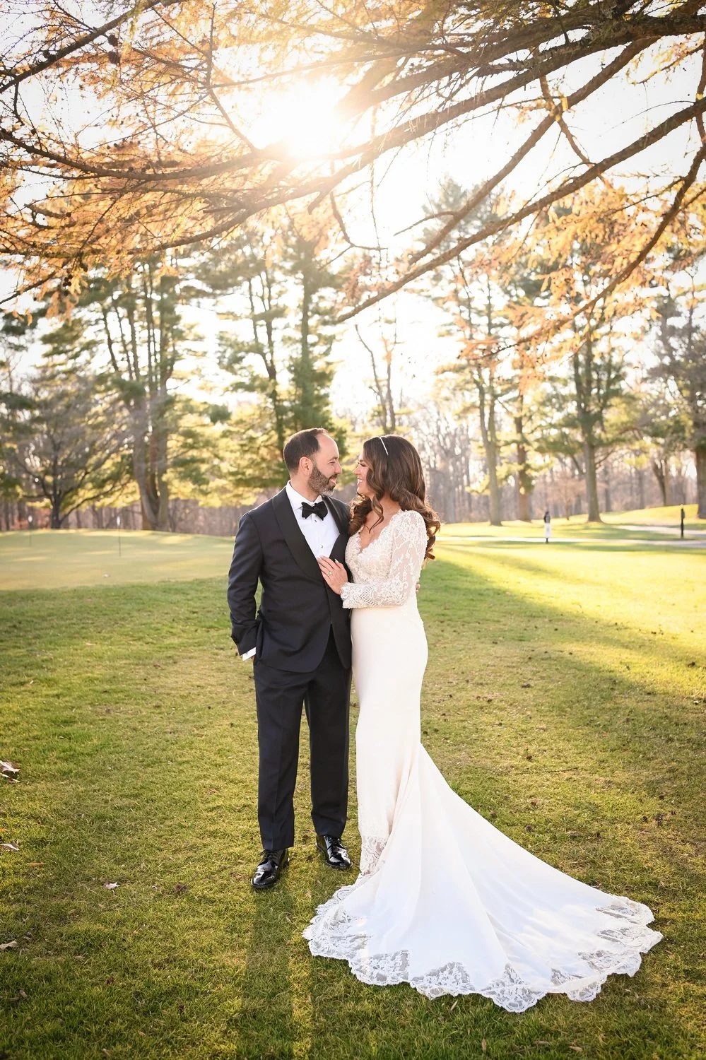 Lindsay and Jason on their wedding day under a tree at Deerfield Golf Club