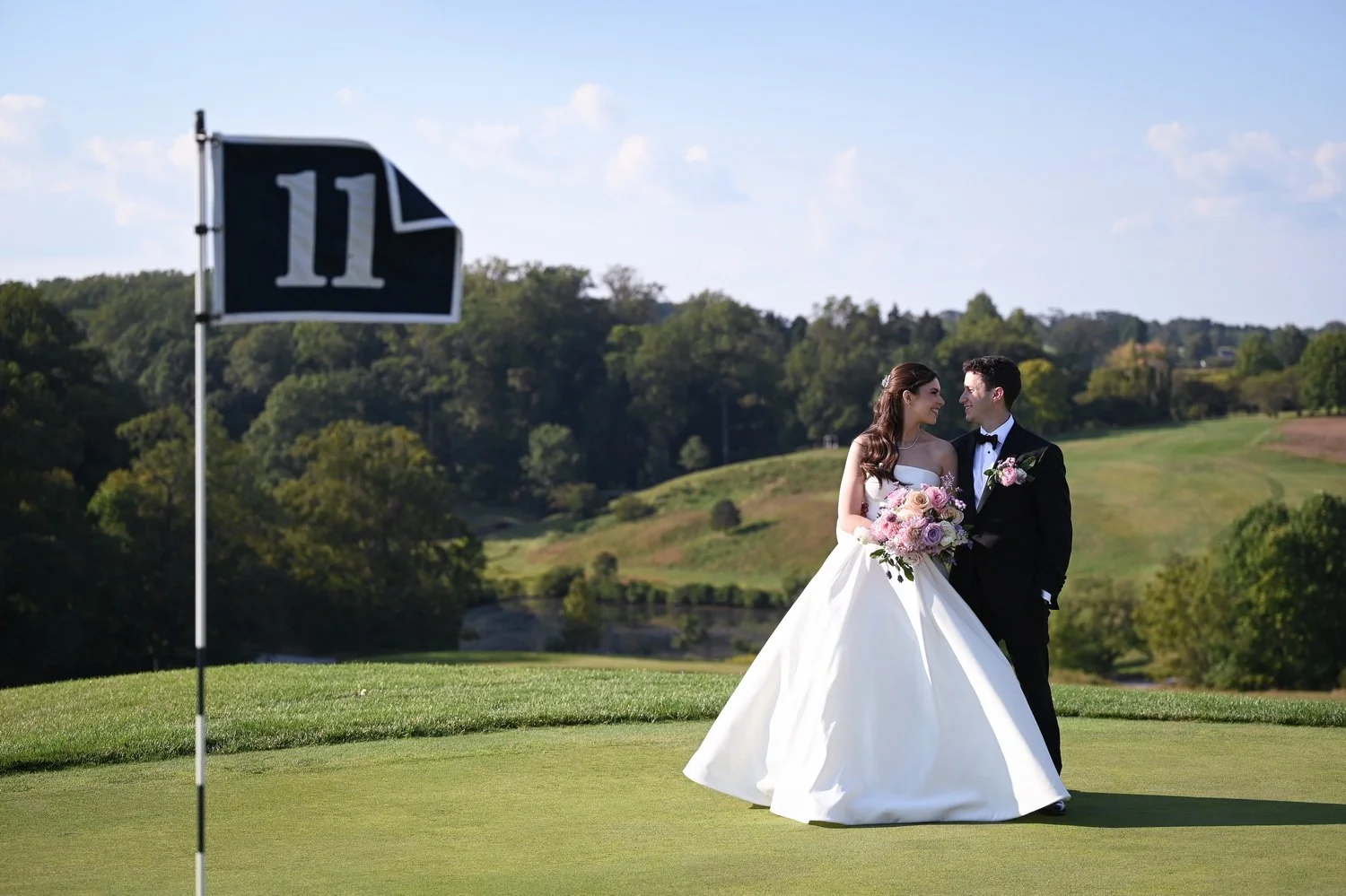 bride and groom at the 11th hole at wilmington country club