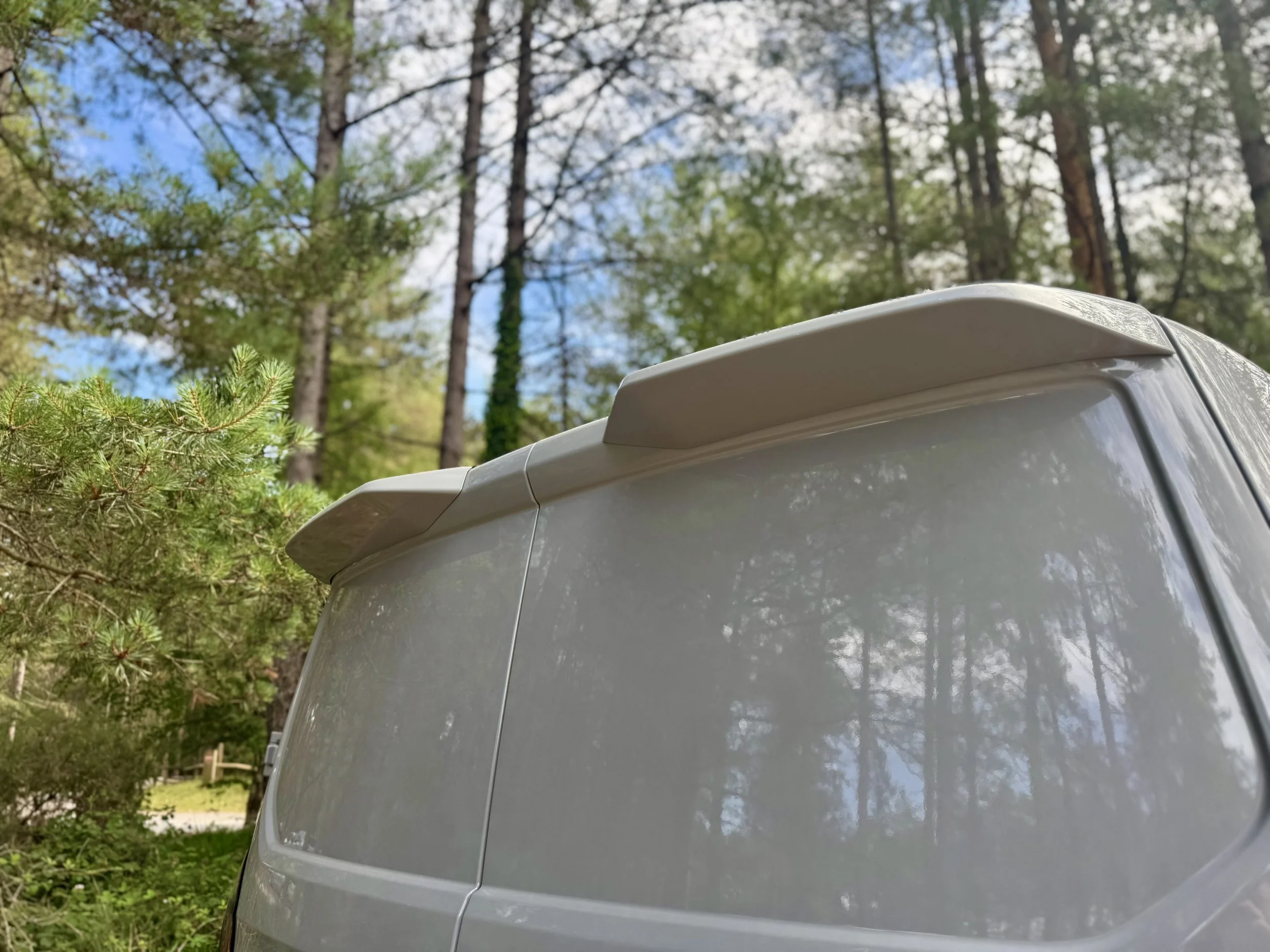 Picture of a matter grey rear spoiler for a 2025 Ford Custom Sport Van