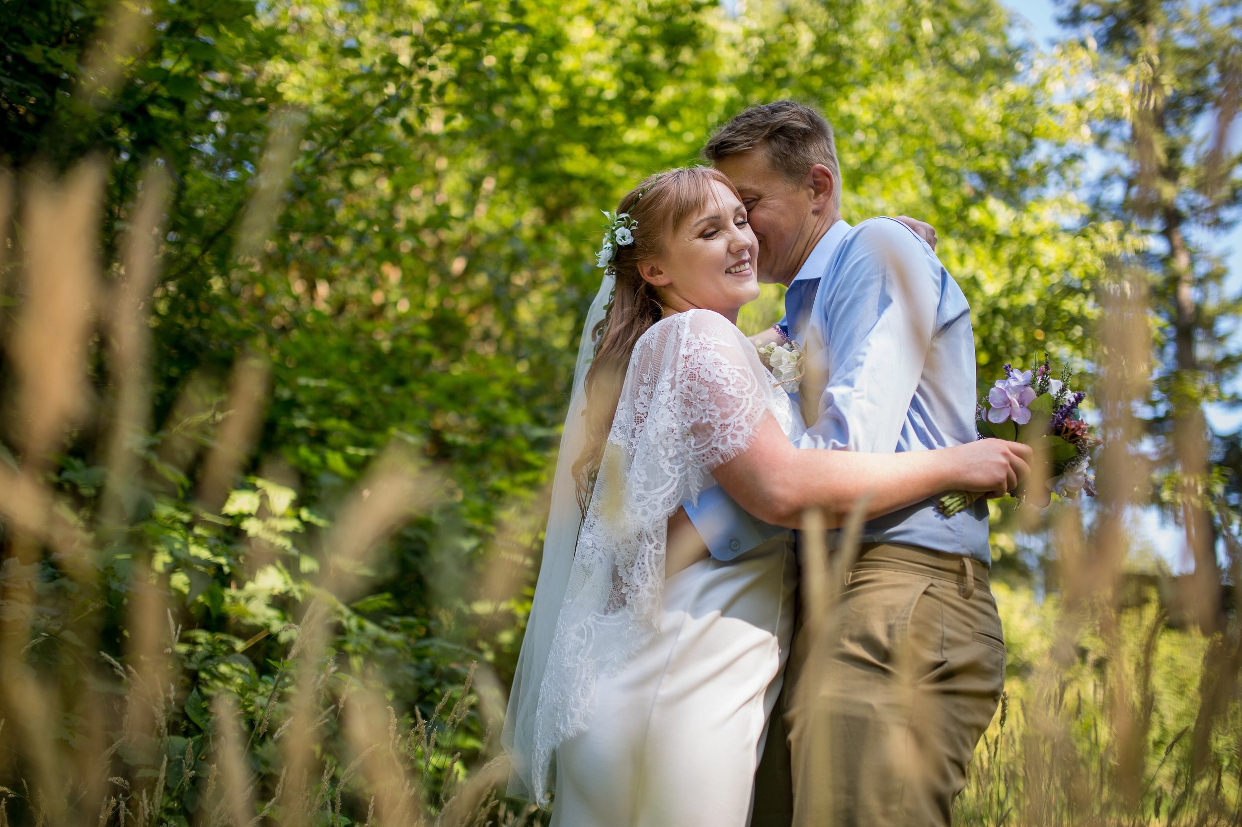 Bride and Groom embrace amongst tall grass at Silver Falls Elopement Photographer