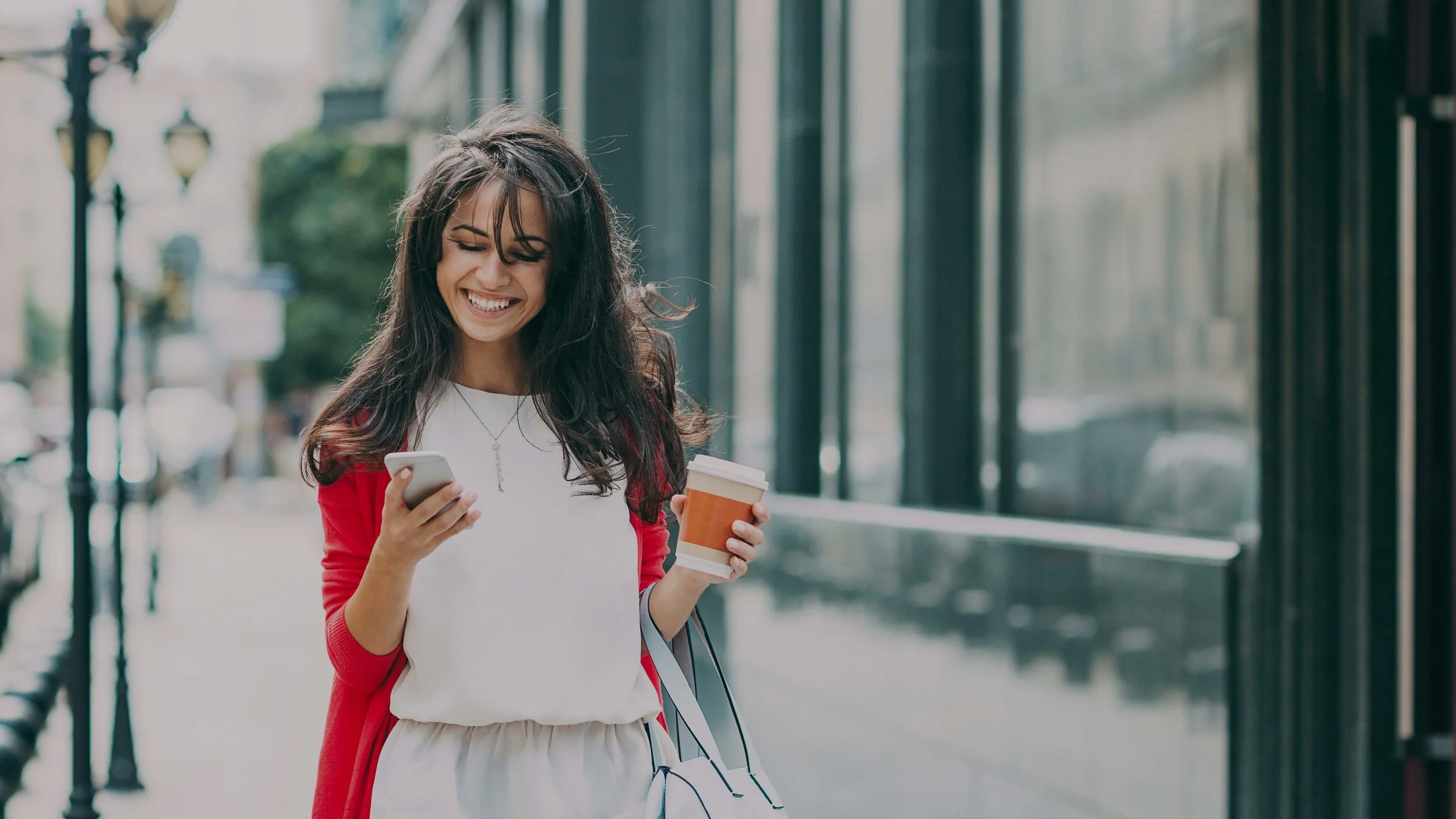 Happy-Young-Woman-Texting-Street-Holding-Coffee-Cup1.jpg