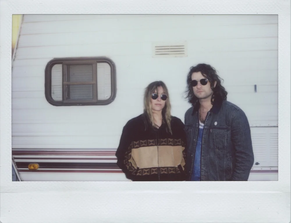 Melissa & Craig of Baybs looking cool by the camper; press photo courtesy of the artists.