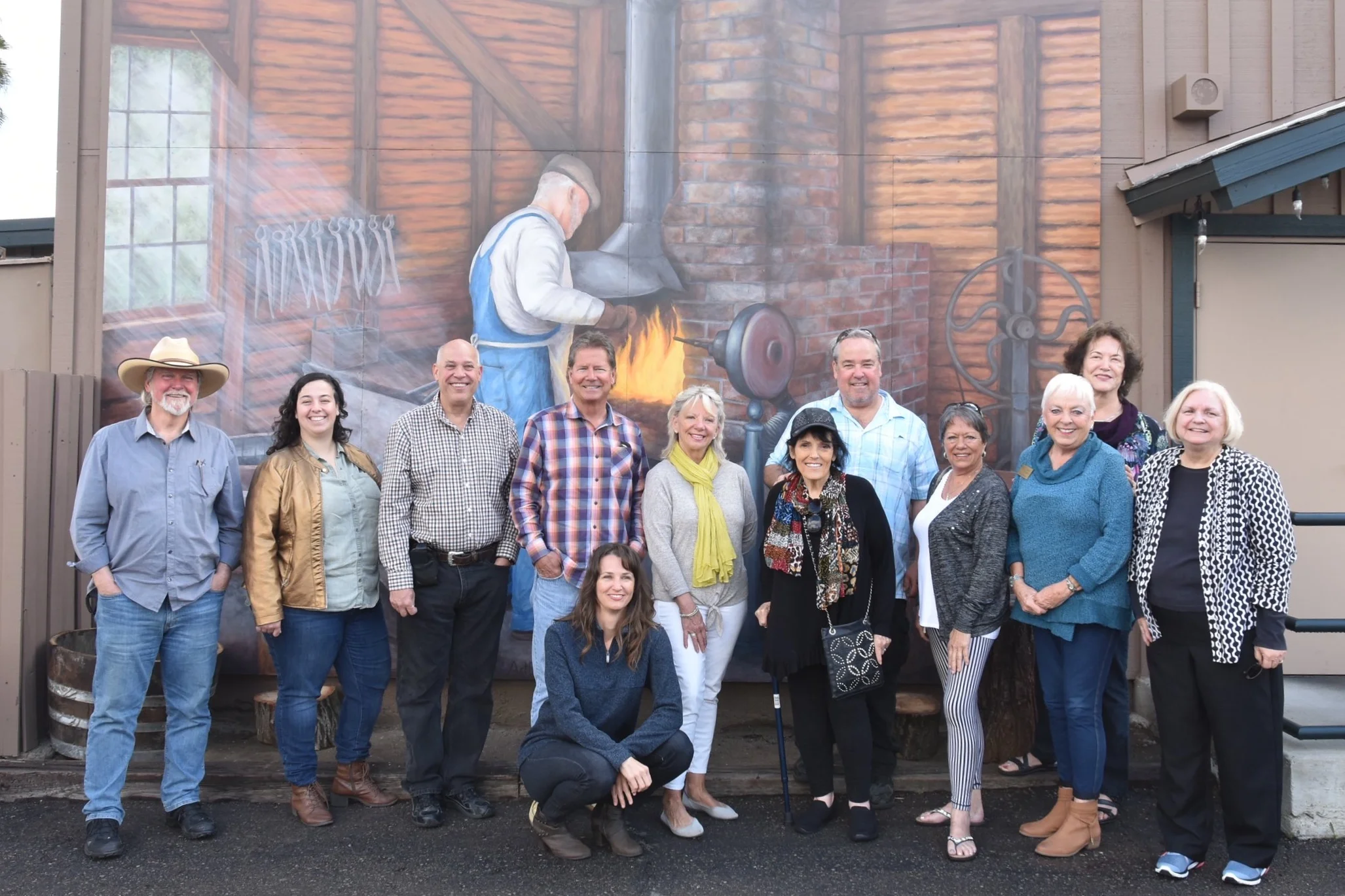 Ramona H.E.A.R.T. Mural Project board members, artist Beata Wojick, D’Carlos Restaurant owners and guests celebrate the dedication of the “Bandy Blacksmith” mural. Photo Courtesy of the Ramona H.E.A.R.T. Mural Project