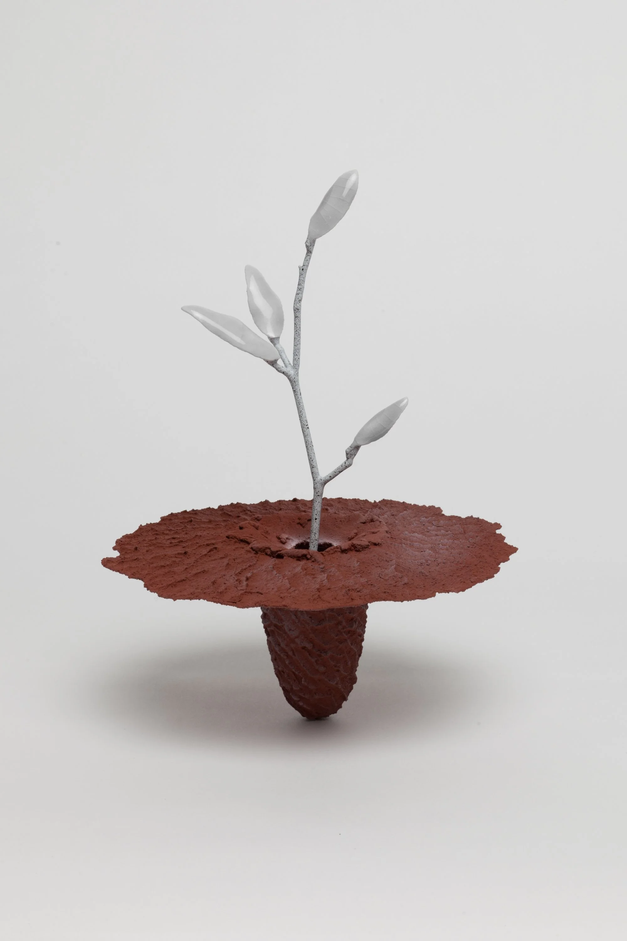   Obelisk (Regolith) , 2023. cremated leaves, rare earth elements, ceramic, twig, resin, steel, glass, maple, walnut. 