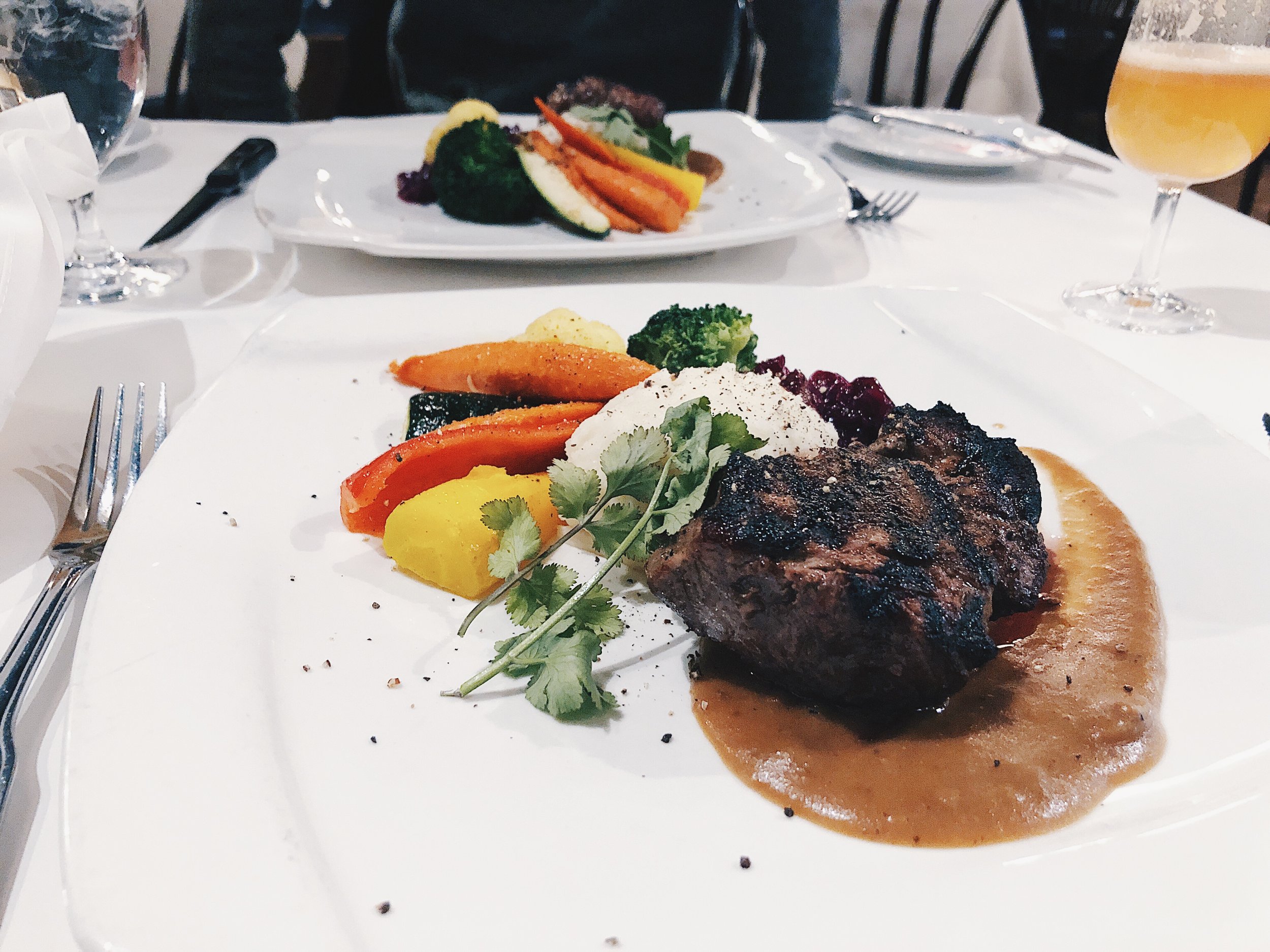 ALBERTA GRADE AAA 6OZ NEW YORK STEAK - charbroiled ‘brick-cut’, black silk truffle demi-glace, roasted garlic mashed potatoes, fresh seasonal vegetables