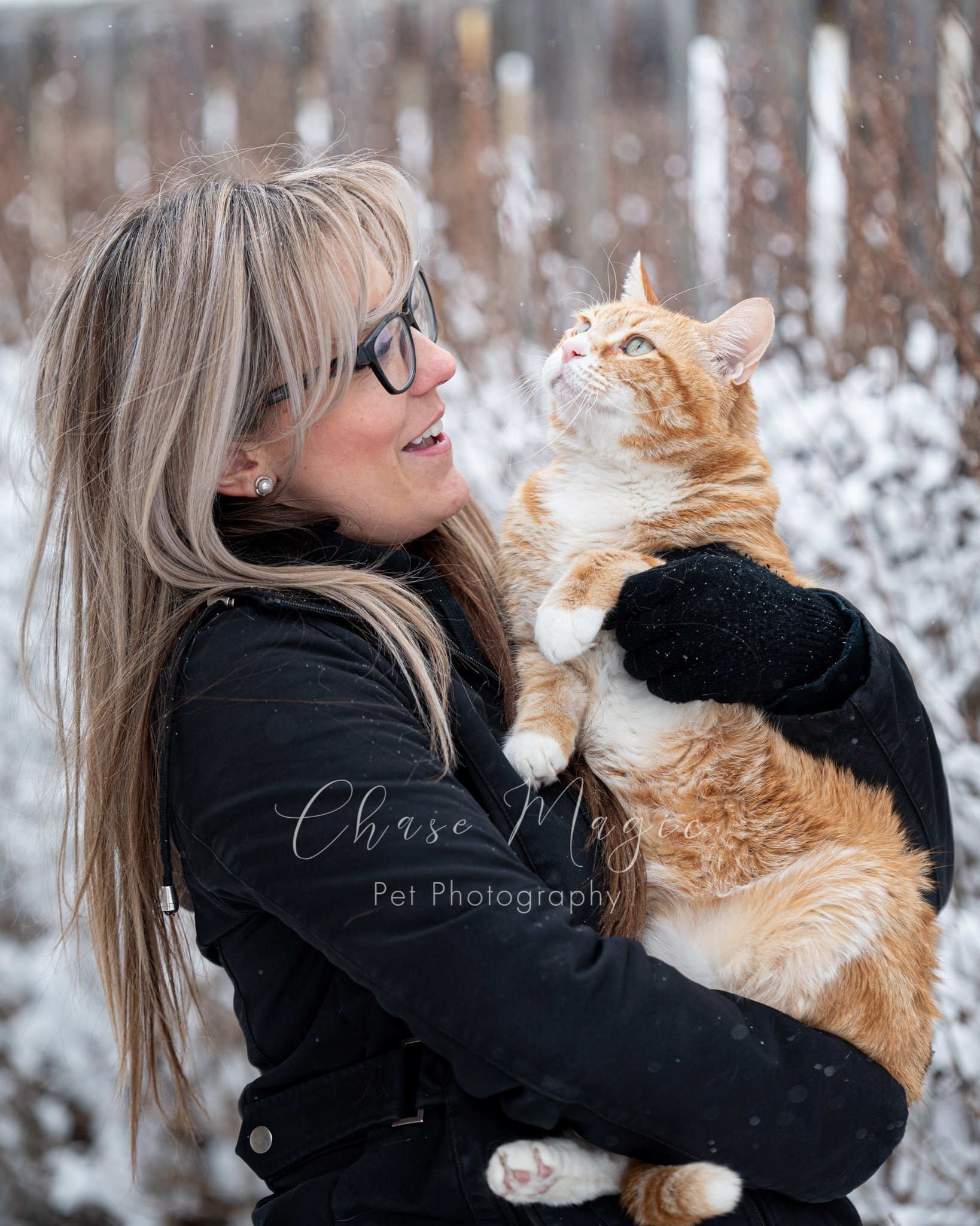 Orange cat and a women enjoying the winter snow