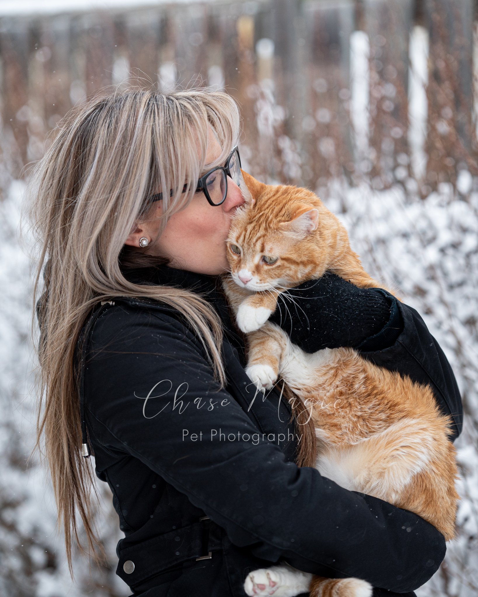 Orange cat and a women enjoying the winter snow and kisses