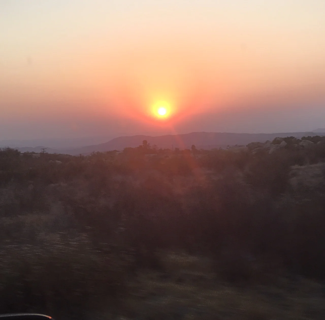 Airstreams parked between the rising and setting sun
