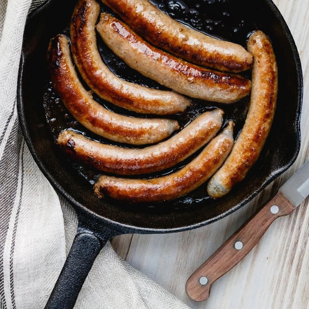 a cast iron pan with beautifully cooked Berkshire breakfast sausage