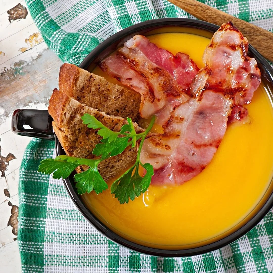 a bowl of soup with bacon made with Berkshire pork stock