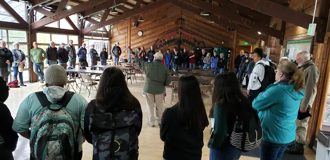 Swinomish elder, Raymond Mitchell, welcomes and educates La Conner grade 8 students on the historic significance of their research site, Lone Tree Point before heading to the beach.