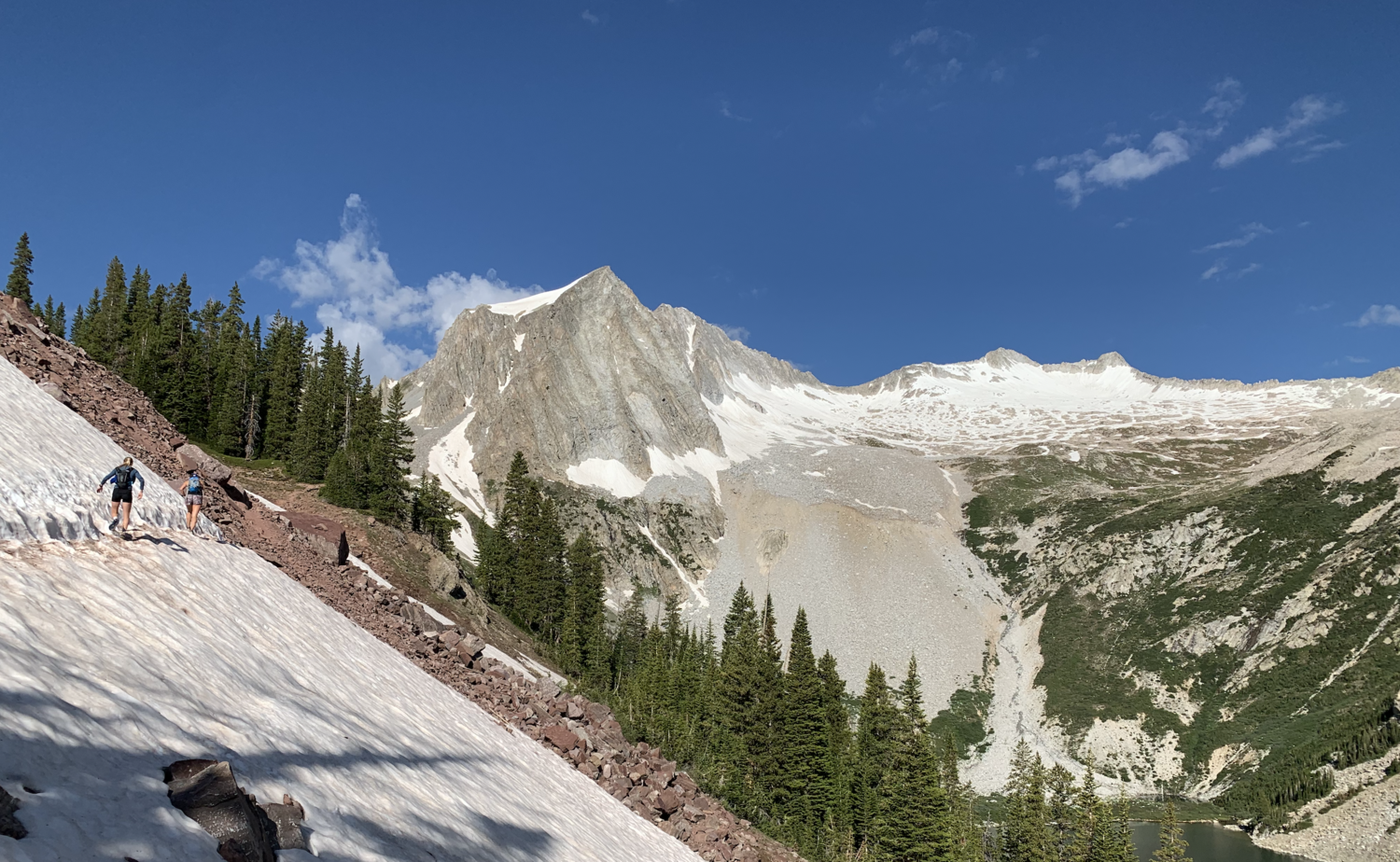 The snowy traverse following Snowmass Lake.