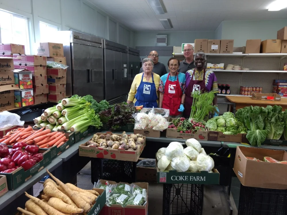 Volunteers set out the weeks donation of produce from General Produce.