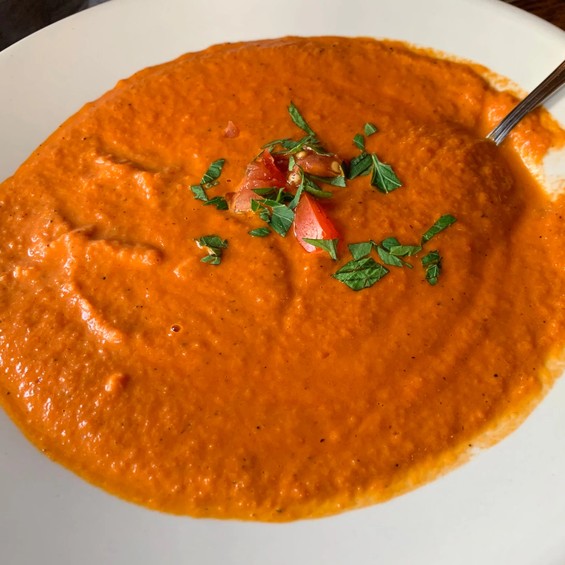 Creamy tomato soup with basil and tomato garnish