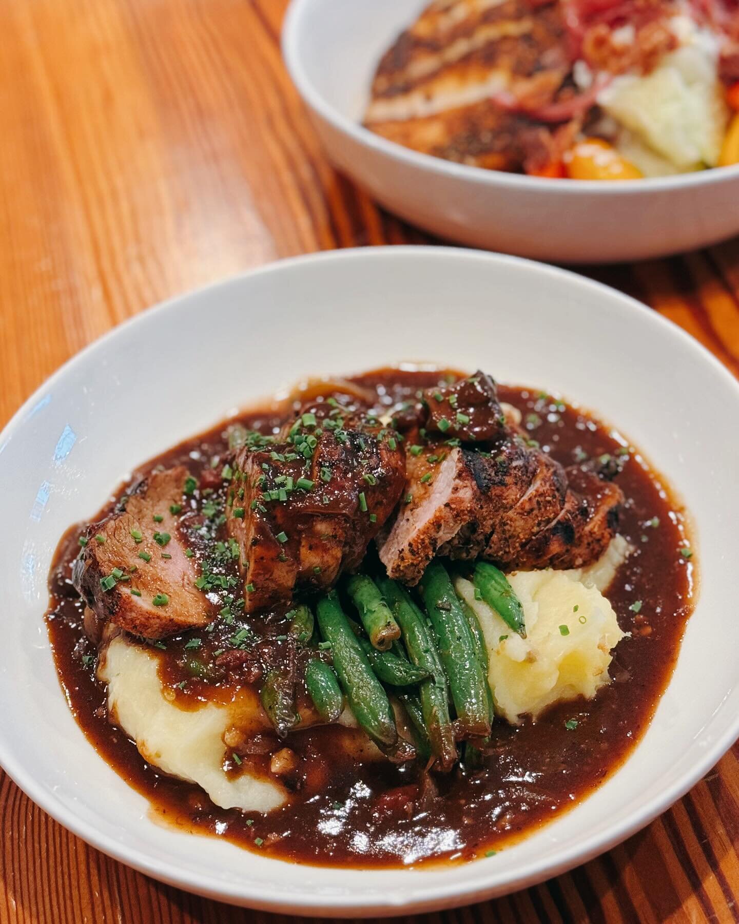 One of Our Entr&eacute;es &bull; Pork Tenderloin served over Yukon Gold Mash &amp; Saut&eacute;ed Haricot Verts and topped with Bacon, Mushroom &amp; Onion Demi Glac&eacute;! 🍽️ Open 11AM to 9PM!