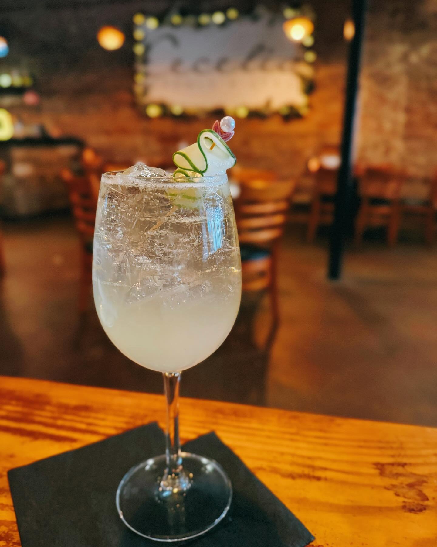 In Need of a Refreshing Cocktail? ✨ Try Our Cucumber St. Germain! &bull; St. Roch Cucumber Vodka &amp; St. Germain Liqueur with Muddled Cucumber, Housemade Rosemary-Infused Simple Syrup, Champagne, Soda Water &amp; Lime and Topped with Cucumber Ribbo