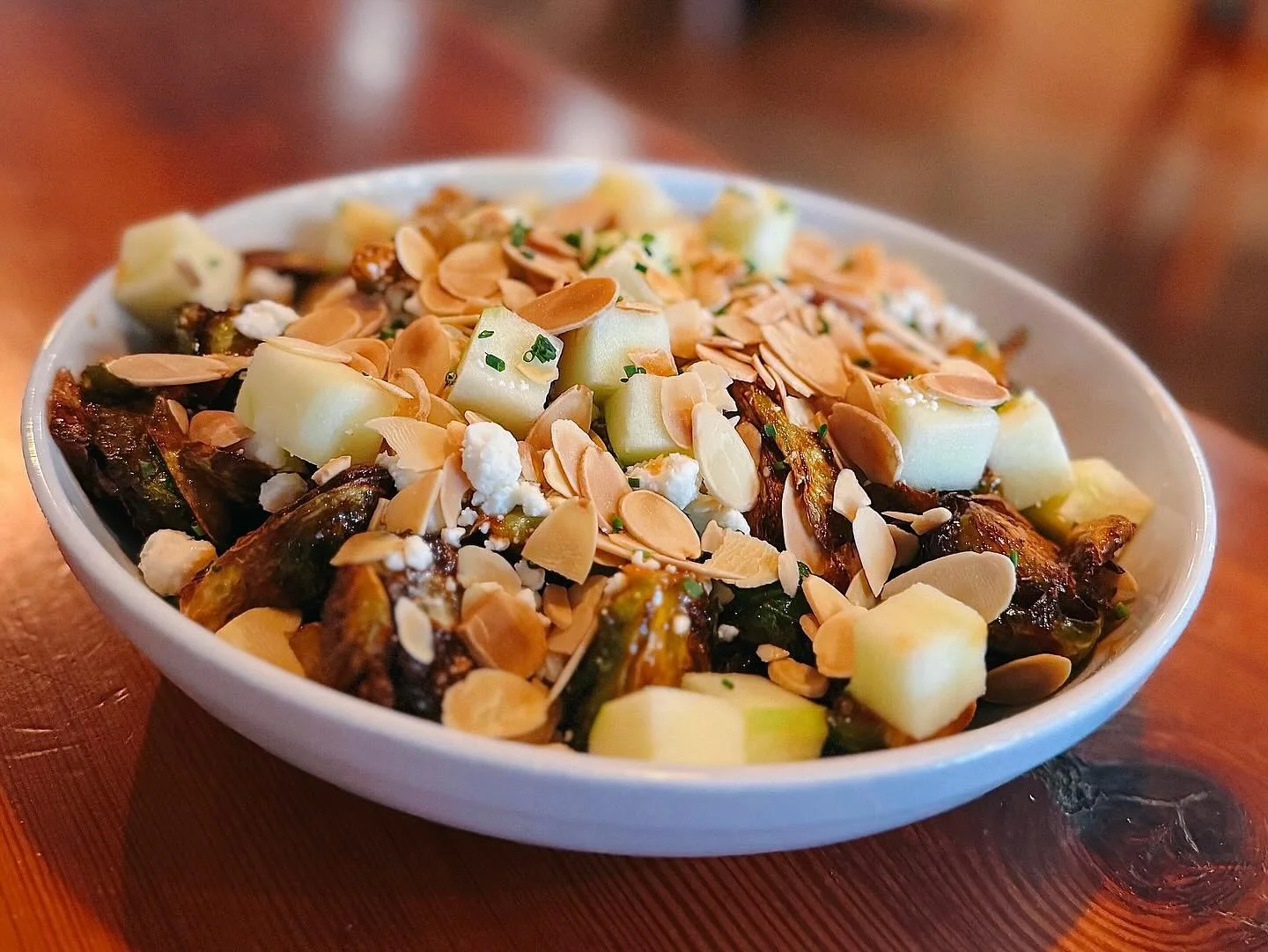 🍽️ Dine with Us &amp; Try Our Sweet-Chili Glazed Brussels Sprouts topped with Goat Cheese, Toasted Almonds &amp; Granny Smith Apples! 🍏 Open 11AM to 9PM!