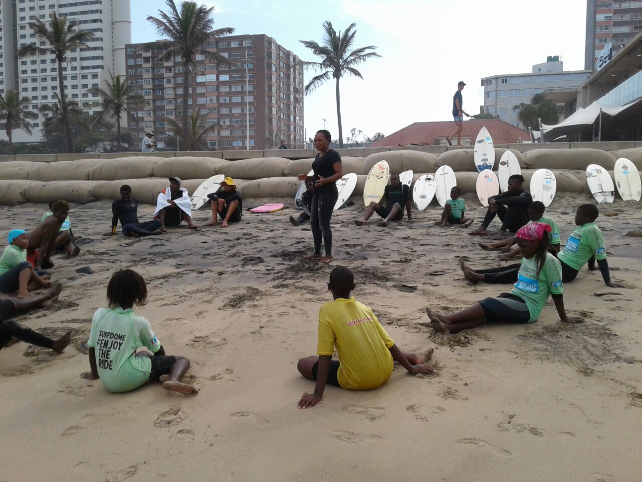 Here S'Lindile (pictured centre) is working with the Surf Club 