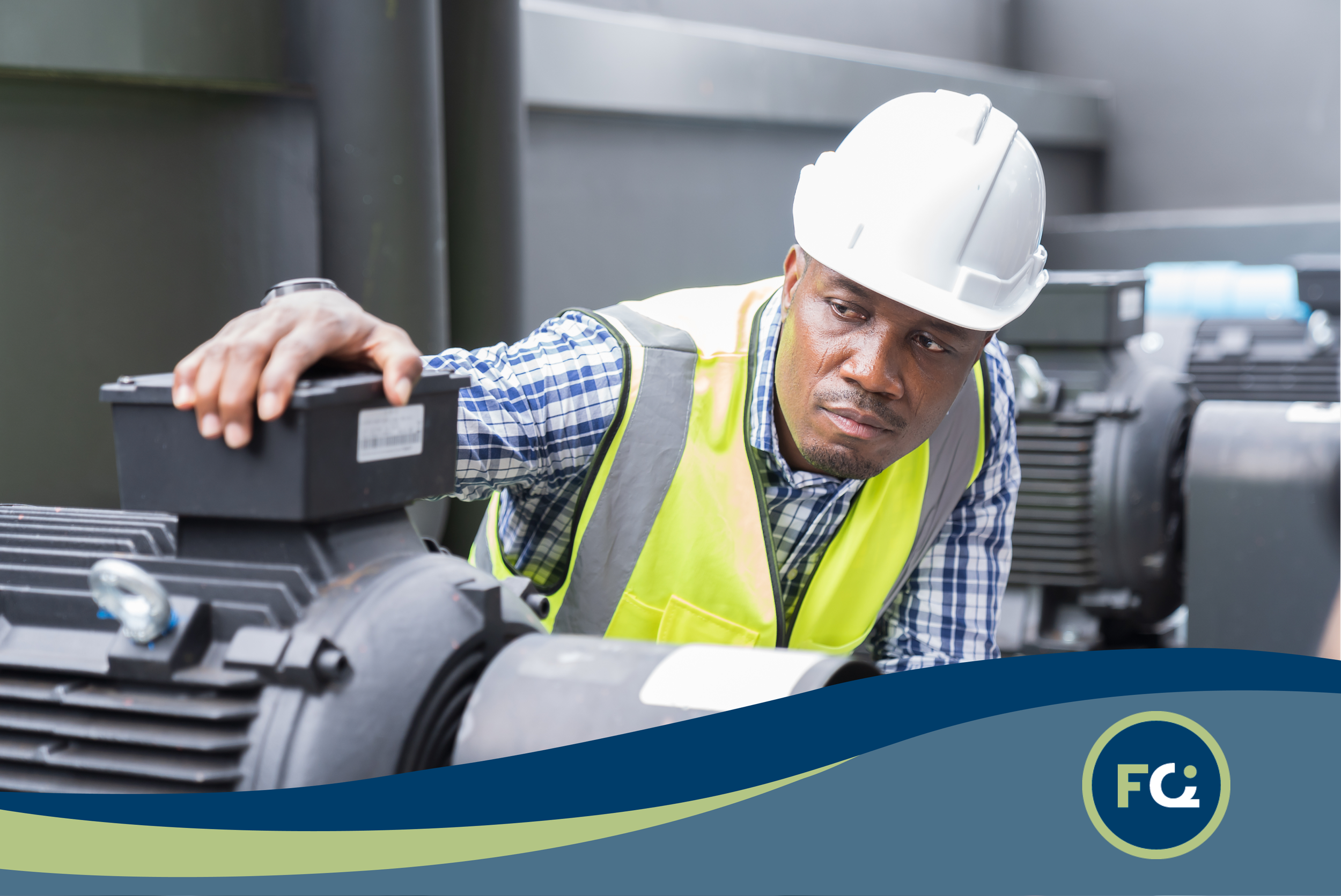 A male worker wearing a yellow safety vest and white hard hat inspecting machinery in an industrial setting.