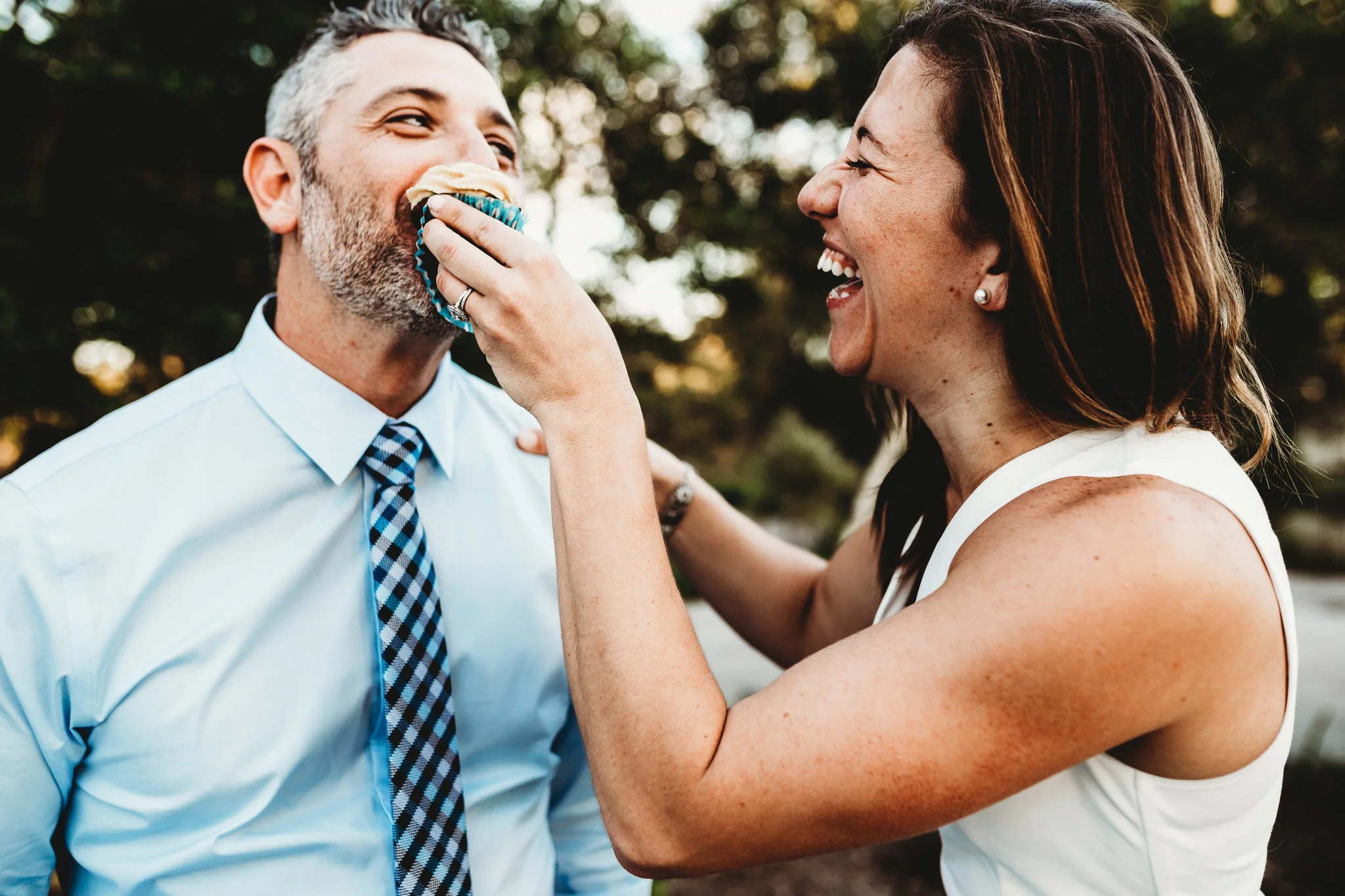 Bride feeds groom cupcake at Lakes Park Fort Myers FL