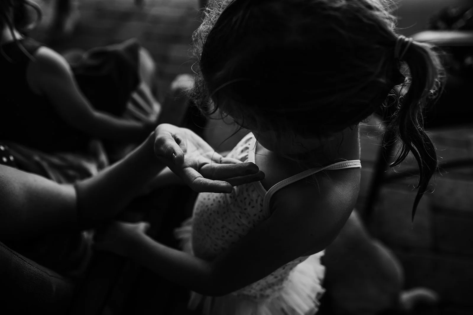 Mom holds out hand to cup daughter's face