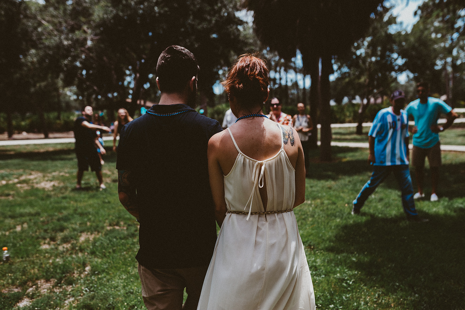  Newly engaged couple walk hand in hand at Three Oaks Park  