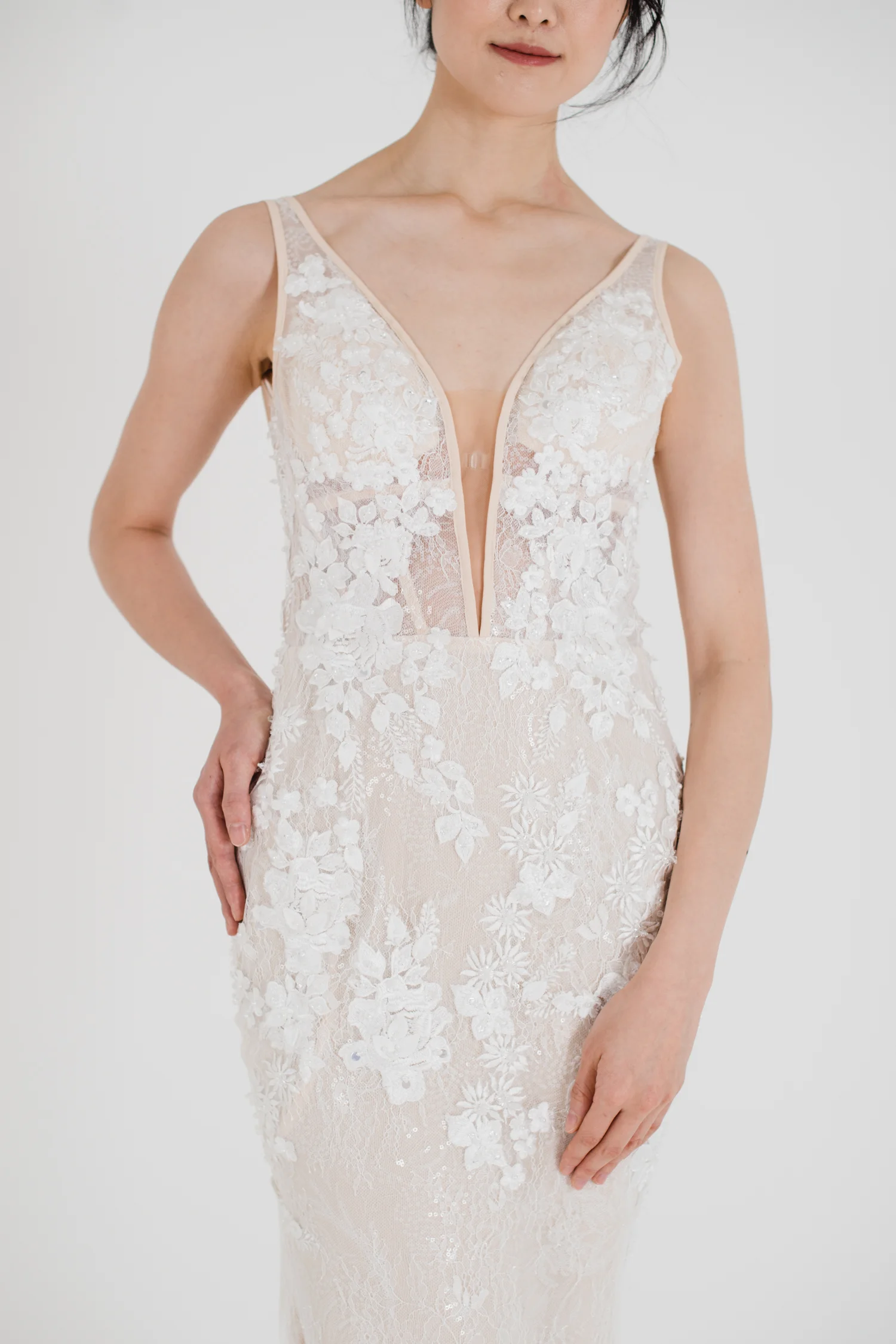 Thea gown peach toned sexy wedding dress with plunging neckline and floral applique details