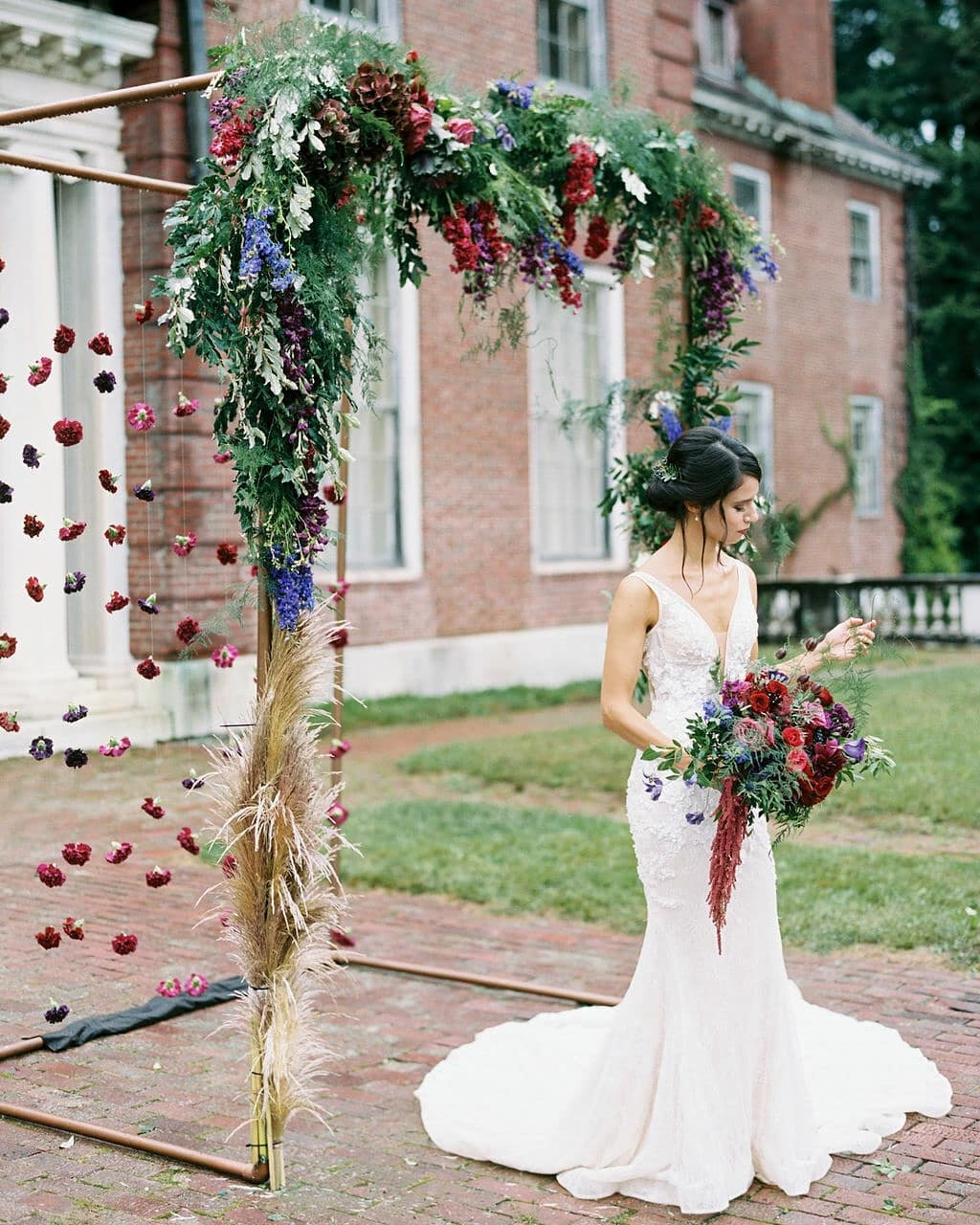 This styled shoot perfectly captures the soft beauty of a spring wedding from the jewel-toned color palette to the bold flower decor. Perfectly complemented by the floral appliques on our Thea gown, this series of photos gives life to a modern fairyt