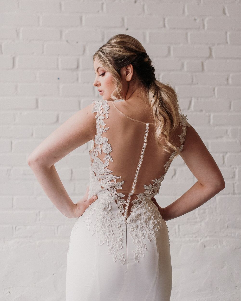 Let&rsquo;s hear some commotion for the back of the dress! This sheath-fit gown is relatively simple until you get to the bodice. Covered in sequined, floral appliques our Tasha gown has an illusion back with button detailing. Made for a spring or su