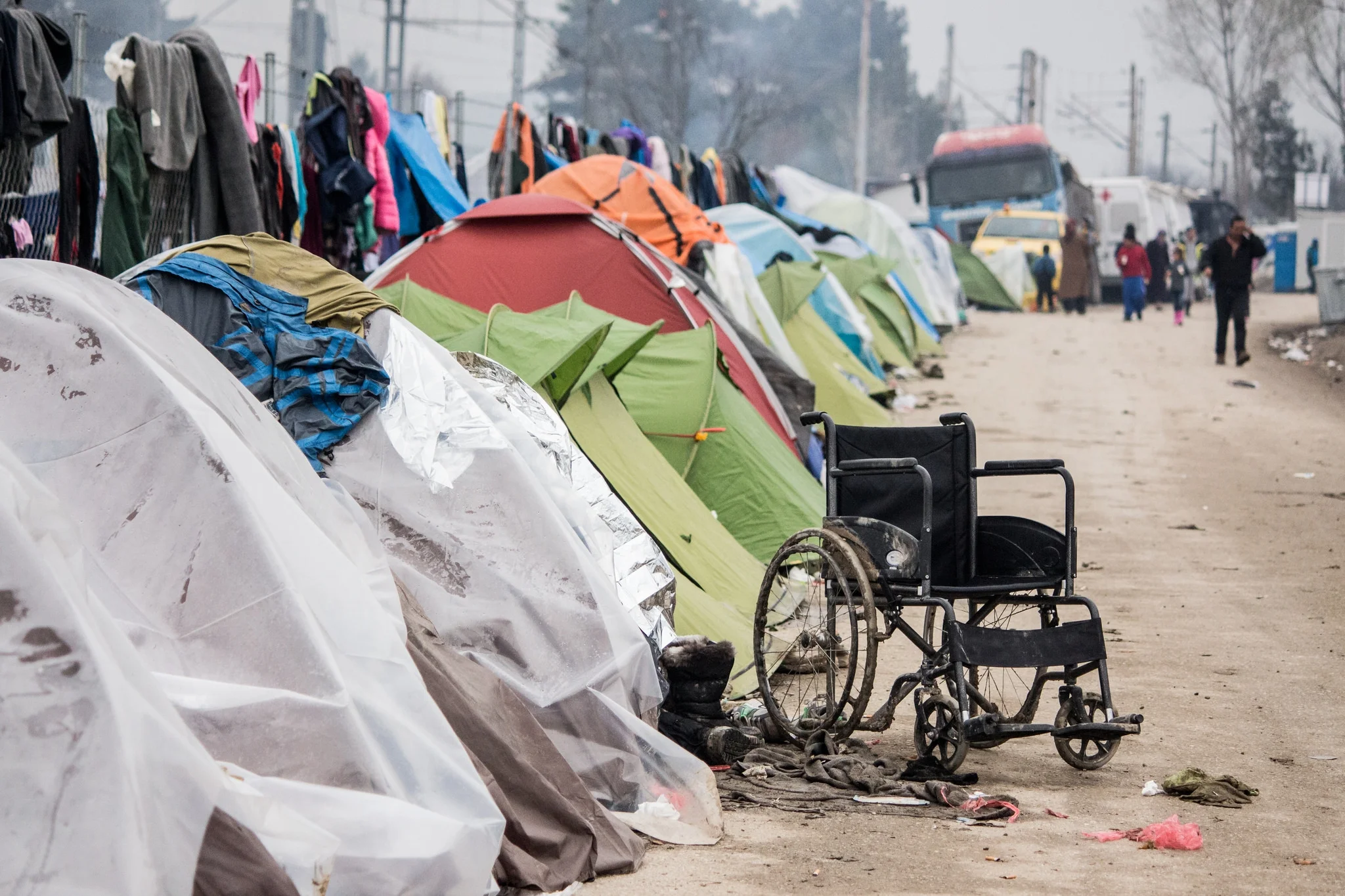 An empty wheelchair sits outside a row of tents in the camp of Idomeni, by the Greece-FYROM border, March 2016. Many of those staying in the camp bore physical signs of the violence and devastation they were fleeing from.