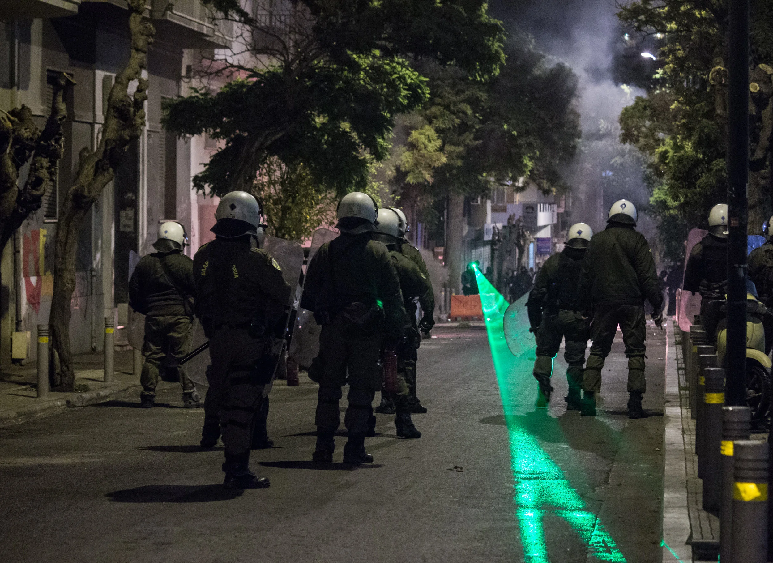 Protesters aim a laser at police during clashes on December 6th 2017, marking the anniversary of the shooting of 15 year old Alexis Grigoropoulos.