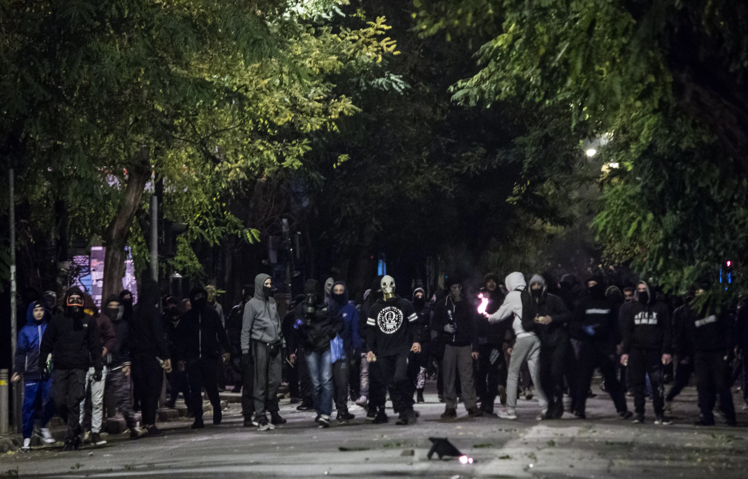 Rioters prepare to throw a molotov cocktail during clashes in Exarcheia, Athens, marking the anniversary of the fatal shooting of a 15 year old boy by a police officer.