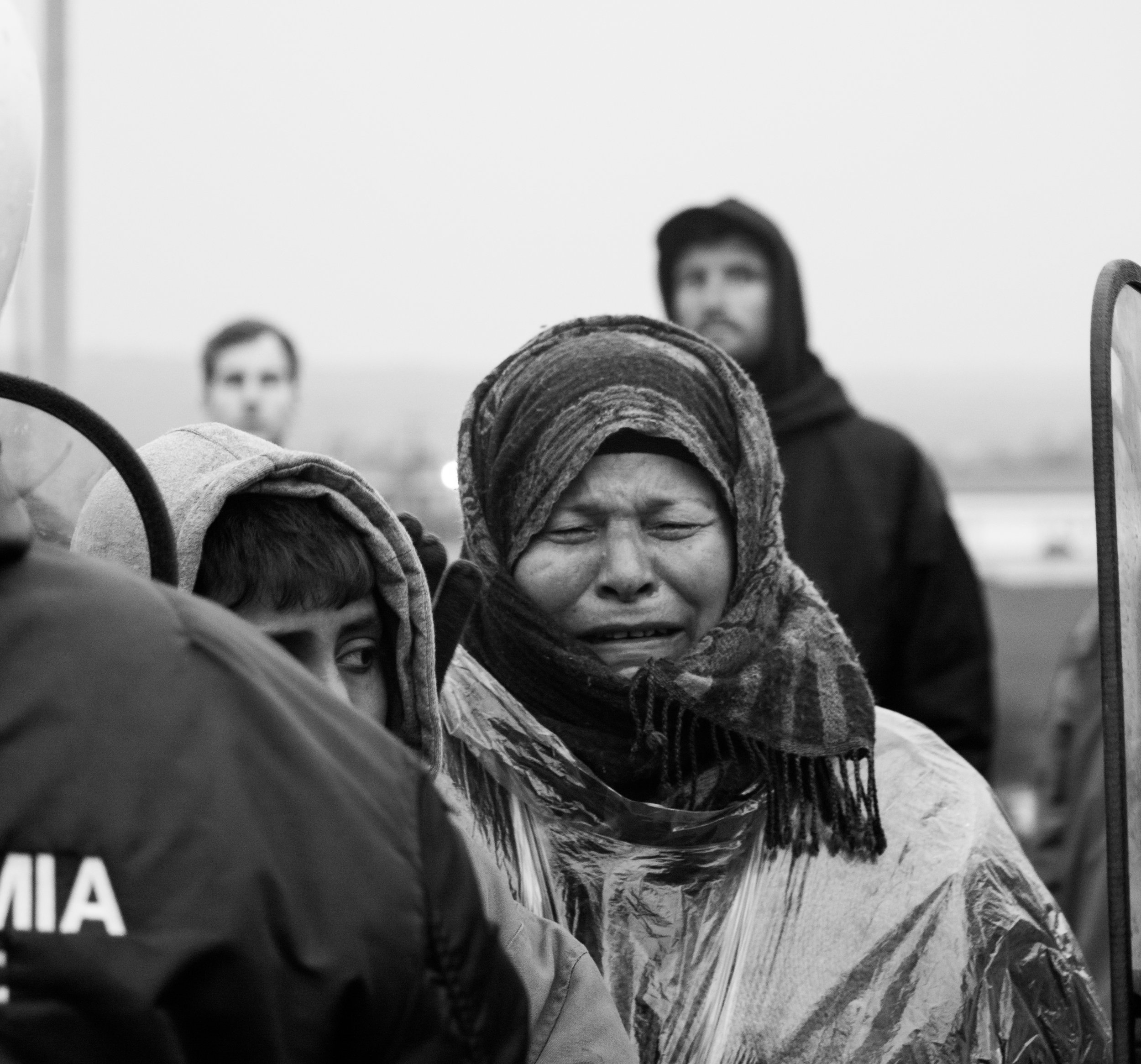 A woman silently sobs at a roadblock protest near the town of Polykastro, where Greek riot police had been trying to non-violently push people back to resume normal traffic in March 2016.