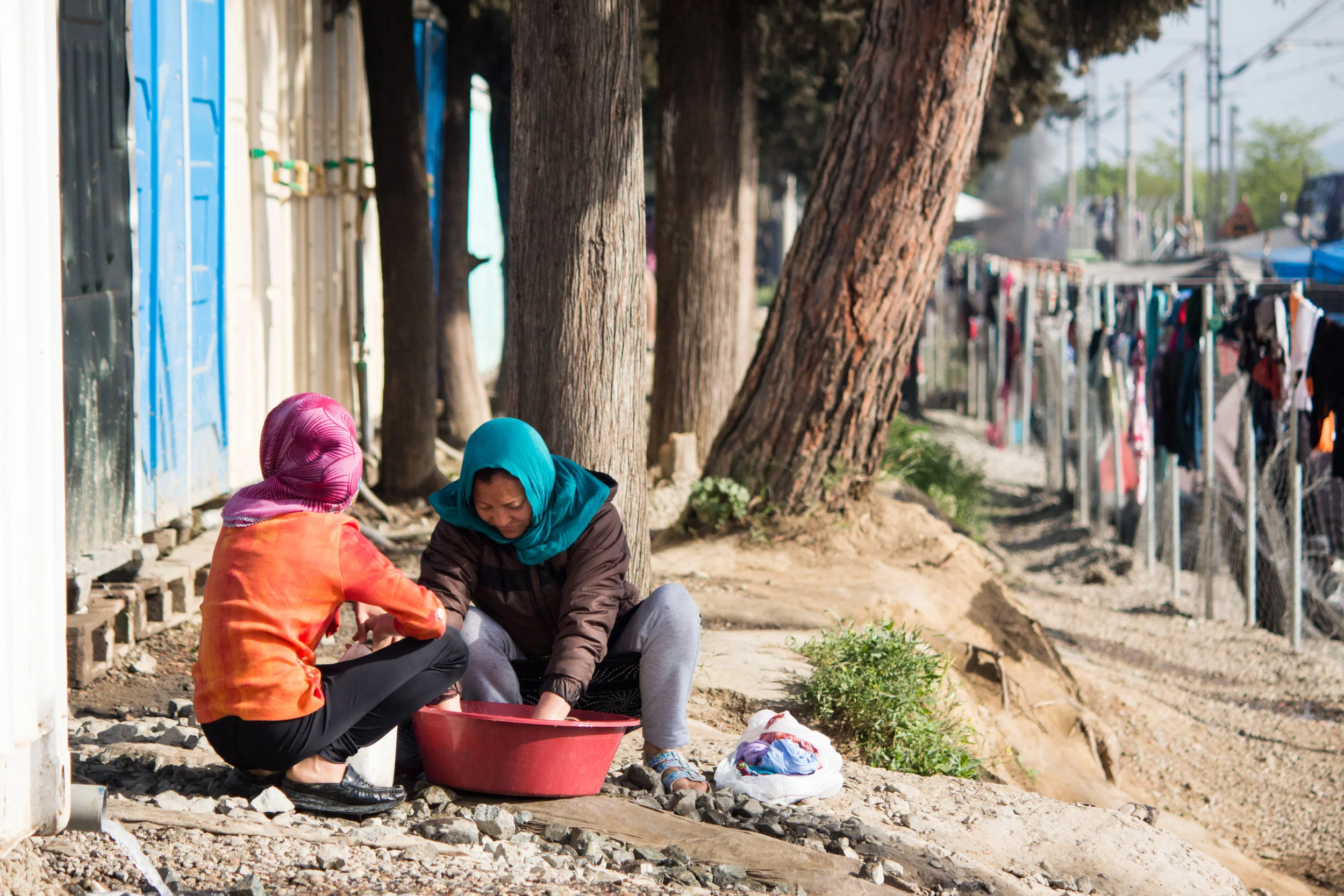 Two women do their laundry on a sunny morning in Idomeni, April 2016. Two-to-three designated water points could be found in the camp.
