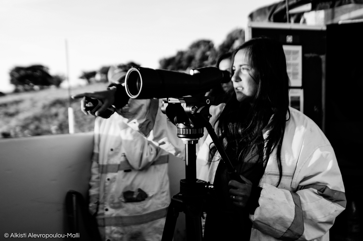 The volunteer team leader points at a suspected dinghy and follows its movements with a telescope. Once a suspected dinghy is identified, the relevant authorities and Search and Rescue vessels are notified.