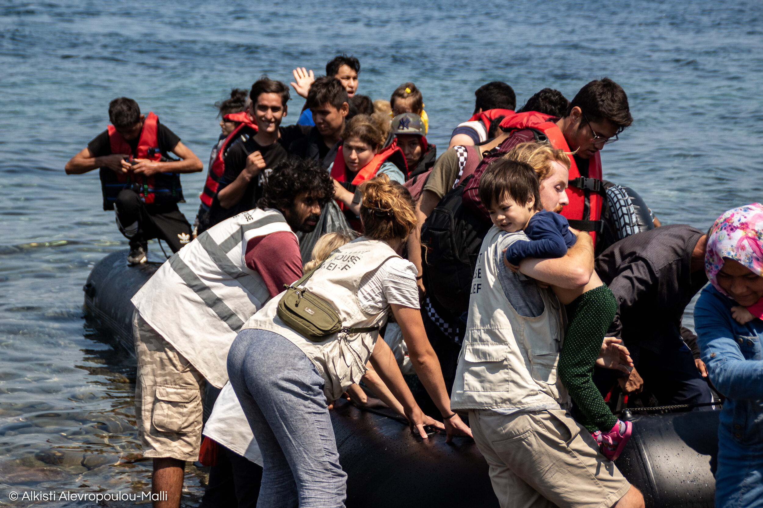 The specially trained volunteer landing team of Lighthouse Relief hold the dinghy steady and help people to disembark in an safe and orderly fashion.
