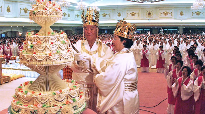 Rev. and Mrs. Sun Myung Moon cut a cake at the Coronation Ceremony of God’s Kingship, January 13, 2001, Cheong Pyeong, Korea.