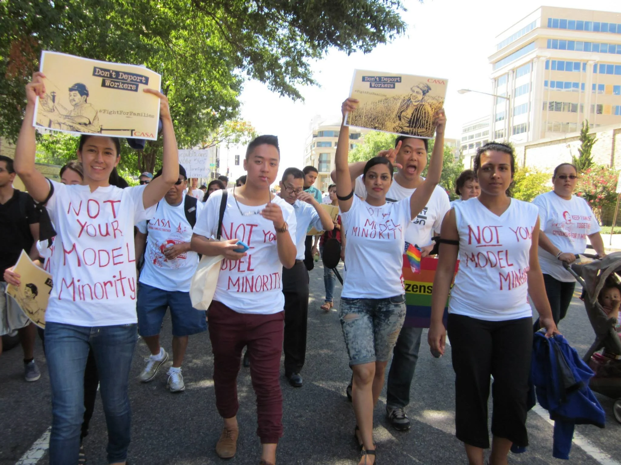 NAPAWF supporters march in the street at a protest and civil disobedience action against deportations.