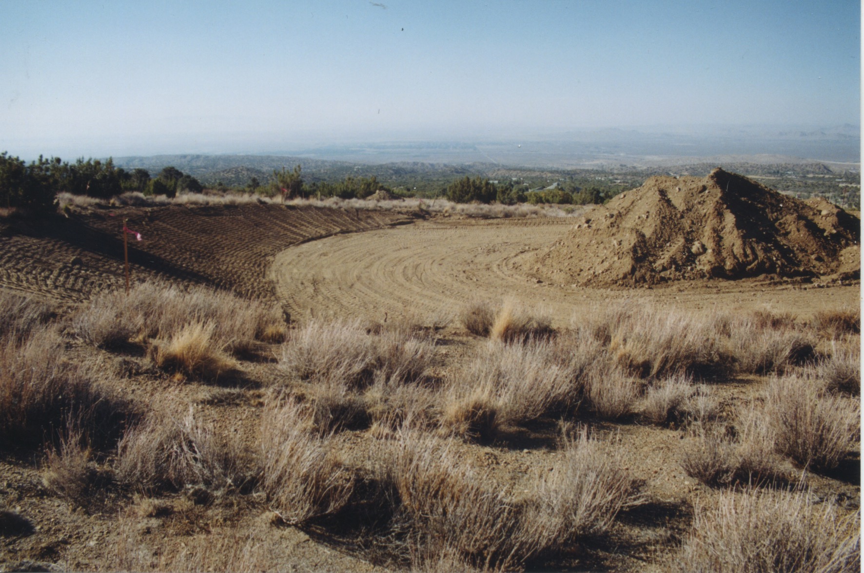 Finished pad with reserved dirt for making adobe blocks
