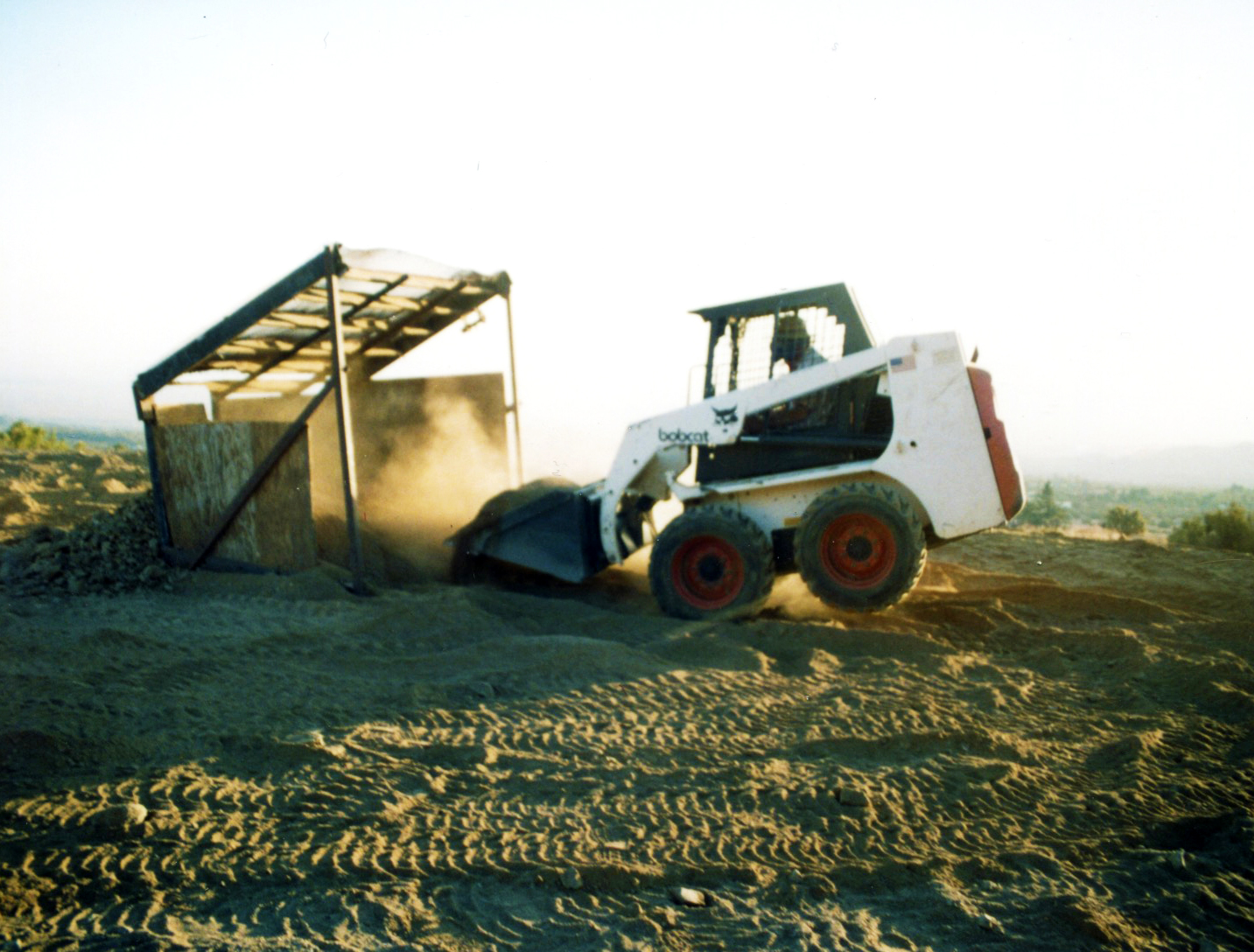 Bobcat wheelie while screening the dirt.