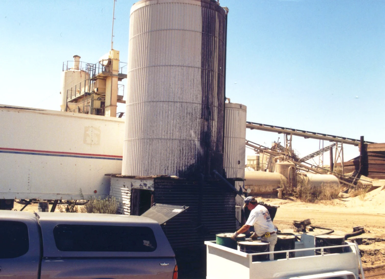 At the local gravel yard, loading asphalt emulsion into our barrels.