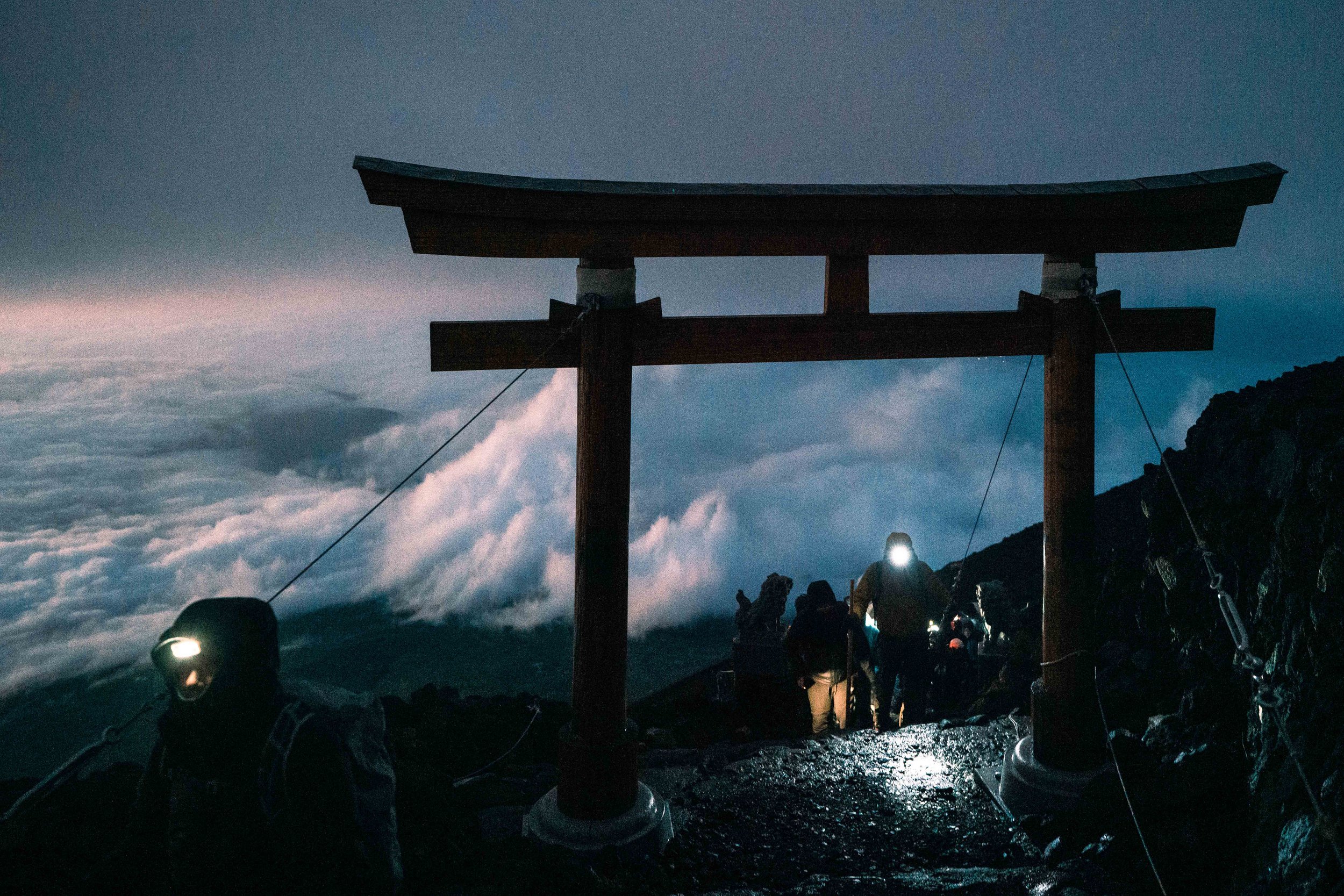 Hikers passing through the last Tori Gate on the Yoshida Trail