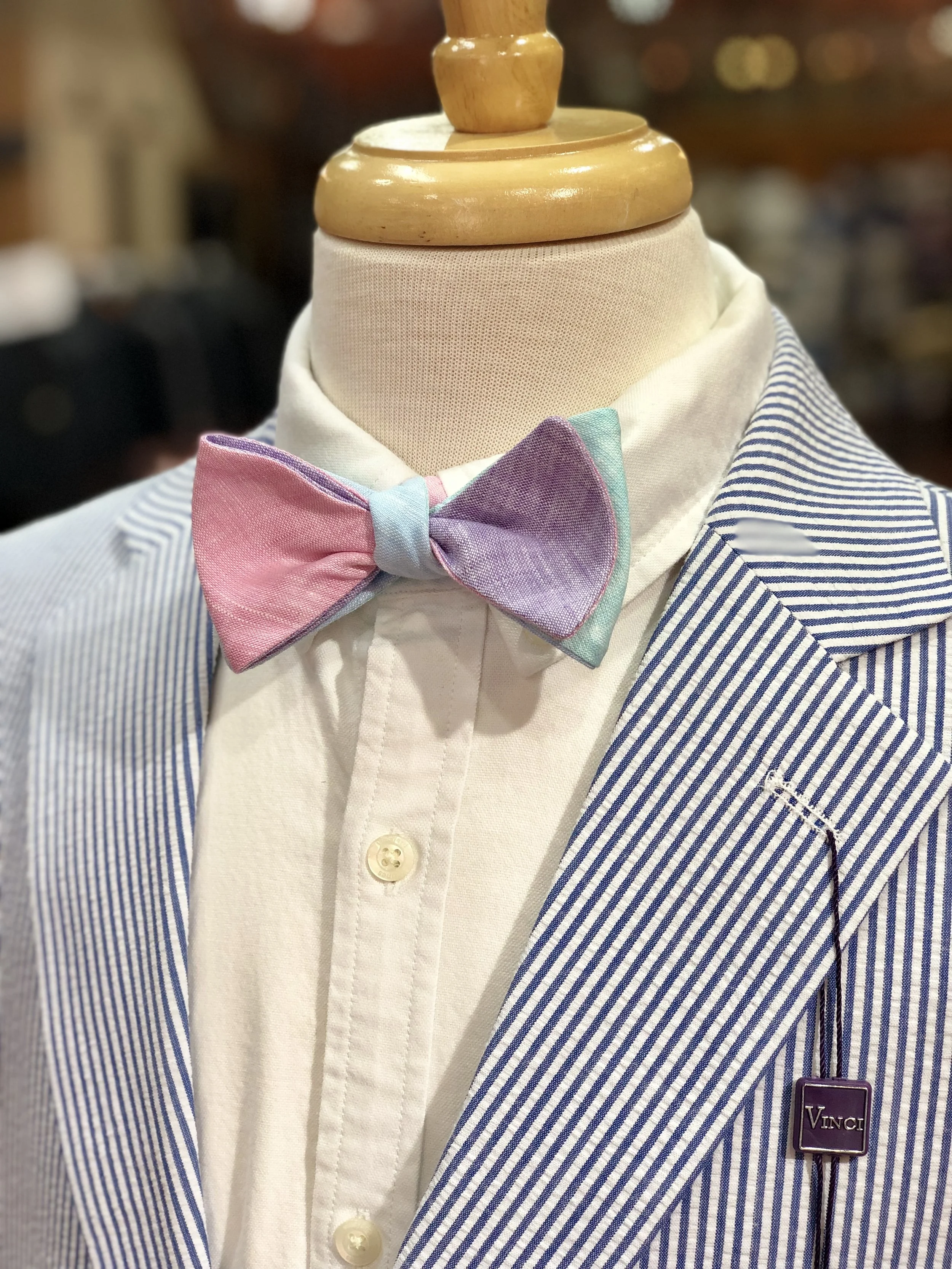 R. Hanauer was established in 1985 when its owner, Randy Hanauer, realized that white pocket squares were a niche that needed to be filled in the menswear market. At that time, the only squares available were the “for blow, not for show” type, and, as Hanauer knew, a handkerchief is much too large for a suit breast pocket. Hanauer’s knowledge in fabric, design and color, combined with his experience as a manufacturers’ representative made his new business endeavor possible. Hanauer’s first pocket squares were designed by Hanauer, then cut, sewn and pressed with the aid of a seamstress, on a single machine which could perform a simulated hand rolled edge on the squares. Much of the pressing and packaging took place on his dining room table. He later found a tailor shop in Rock Hill, South Carolina, that would produce his products. The squares were well received by the retail stores. Hanauer soon added a few new patterns, such as tattersalls, plaids and paisleys. As he grew in talent and confidence, bow ties and matching cummerbunds were added to his product line. In 1990, R. Hanauer, Inc. expanded operations as the company moved into its own workshop in Fort Mill, South Carolina. The company has since tripled the size of the facility. R. Hanauer products are proudly made in the USA from imported fabrics, and Hanauer attributes much of his success to, “good honest working relationships and a product based on quality.” One relationship that is incredibly important to the R. Hanauer business is family. Randy's son, Randall Hanauer, is now in partnership with his father.