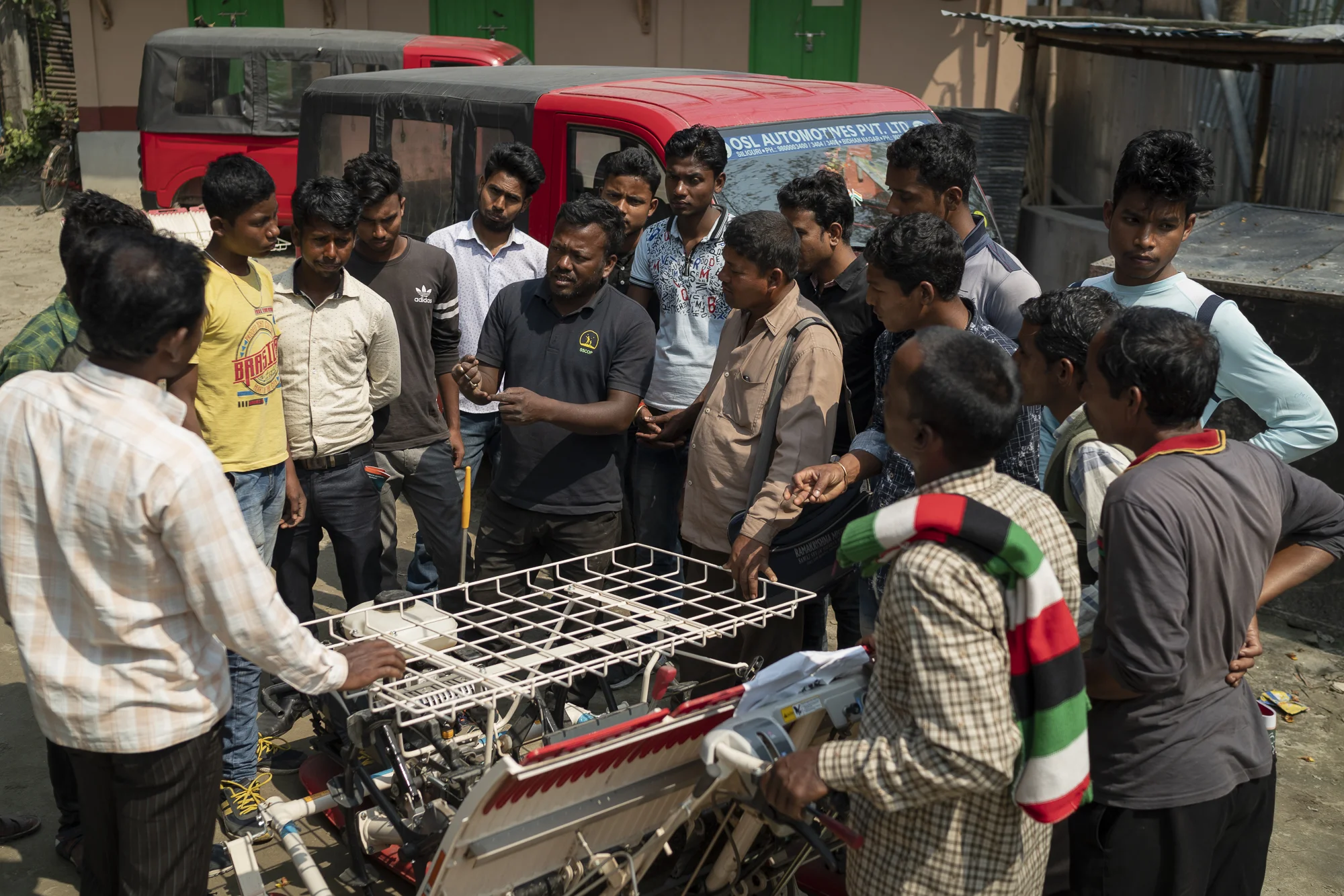 Staff from Satmile Satish Club share information with farmers and machine operators interested in using a mechanical rice transplanter as part of their machinery portfolio.