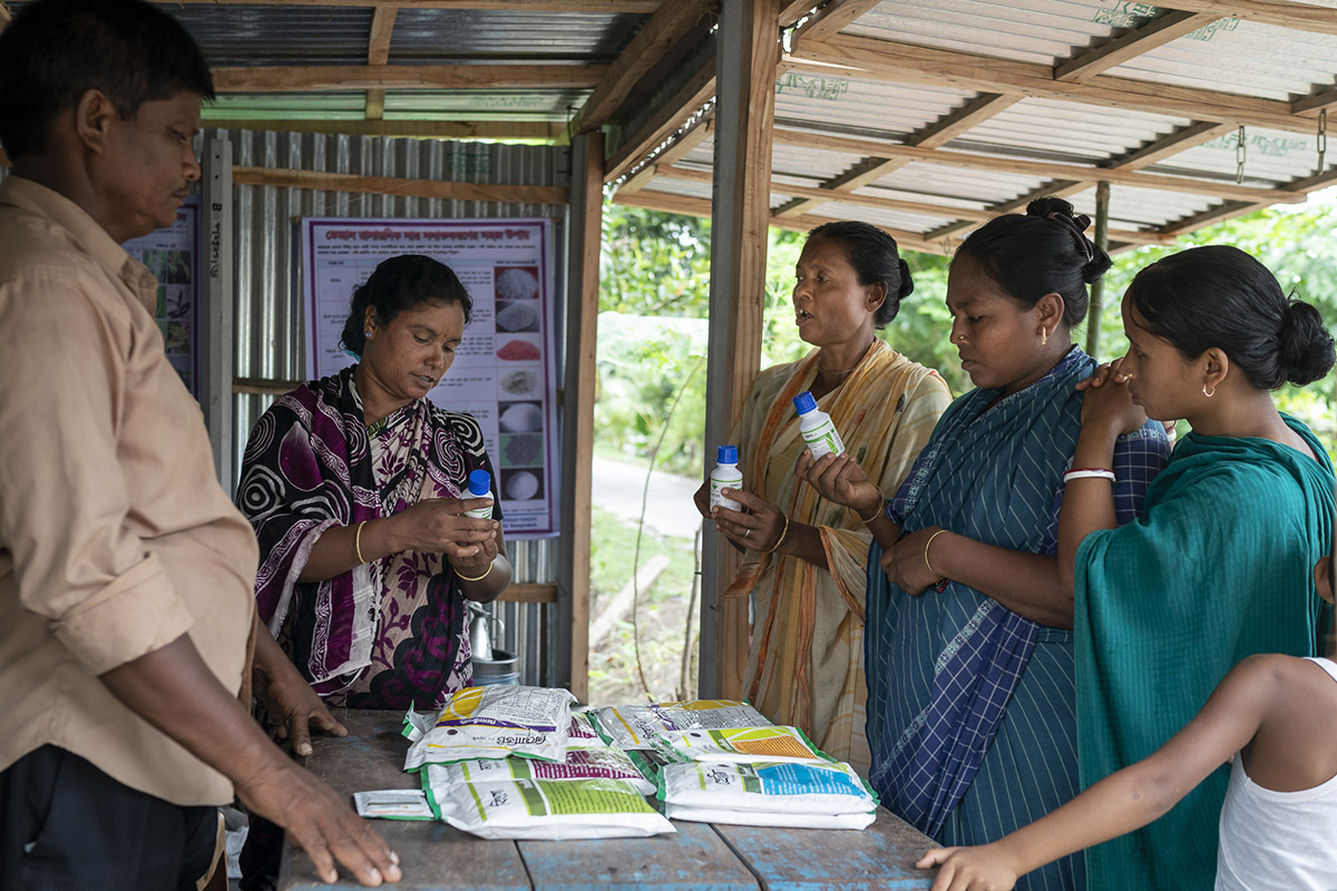 Robi Mardi and wife Pranati Murman talk to local farmers about a range of the agri-input supplies their shop sells.