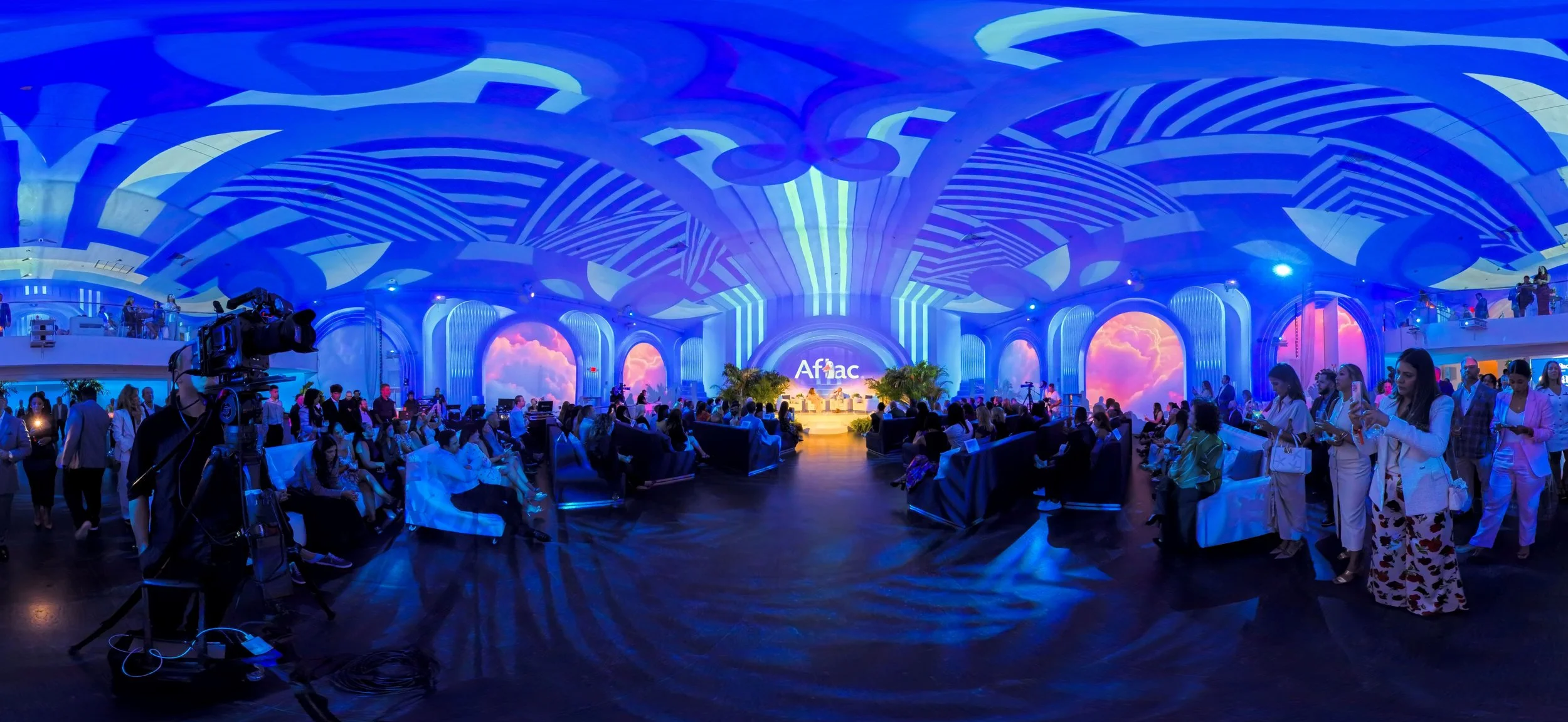 Immersive corporate event environment with architectural projection