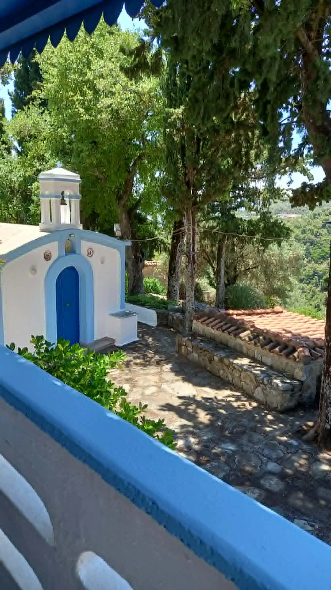 a_farmhouse_a_cabin_and_a_church_blue_church.jpg